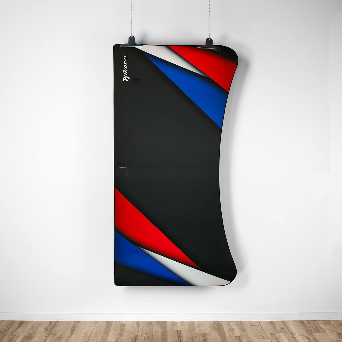 Black punching bag hangs next to an Arozzi Europe Arena Mousepad.