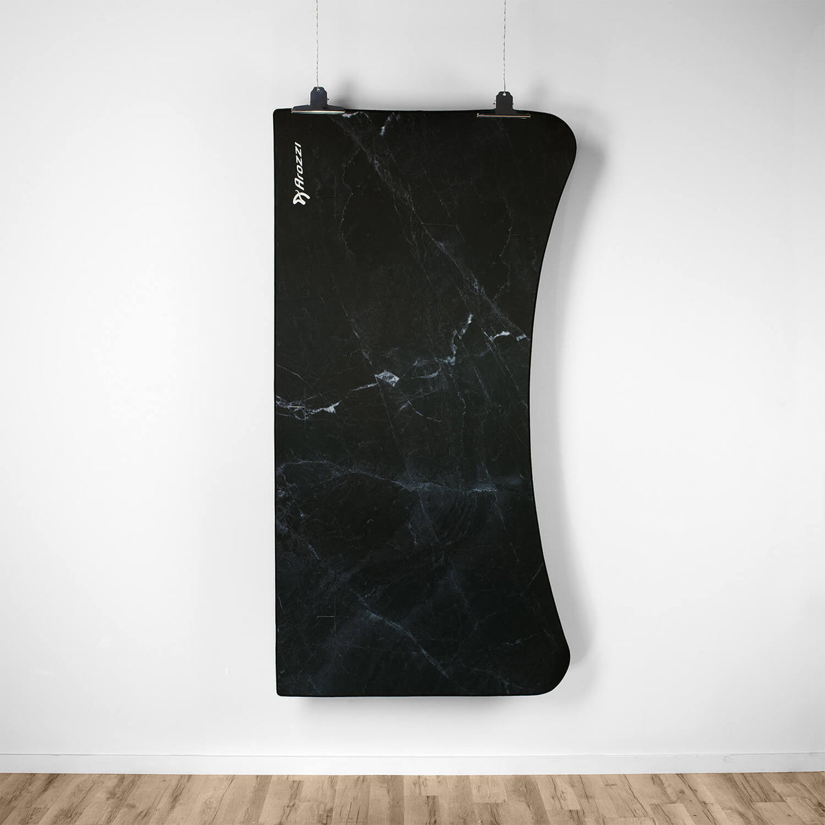 Arena Mousepad by Arozzi Europe, curved black marble, cable-suspended on white wall, wood floor.