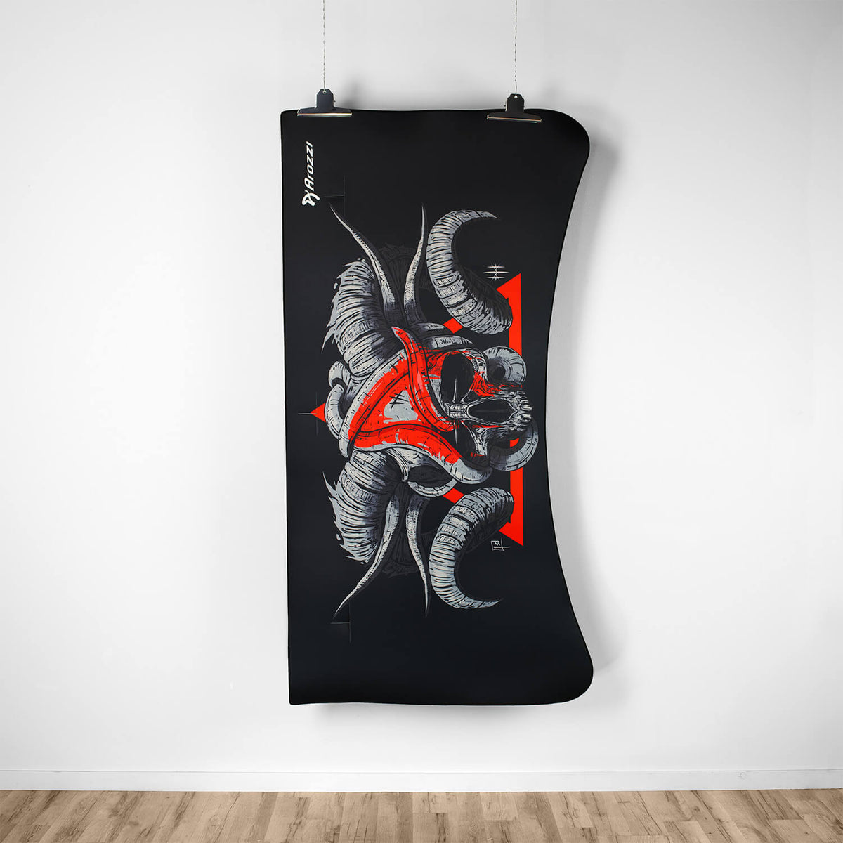Arozzi Europe Arena Mousepad with skull & red triangle design hangs on a white wall.