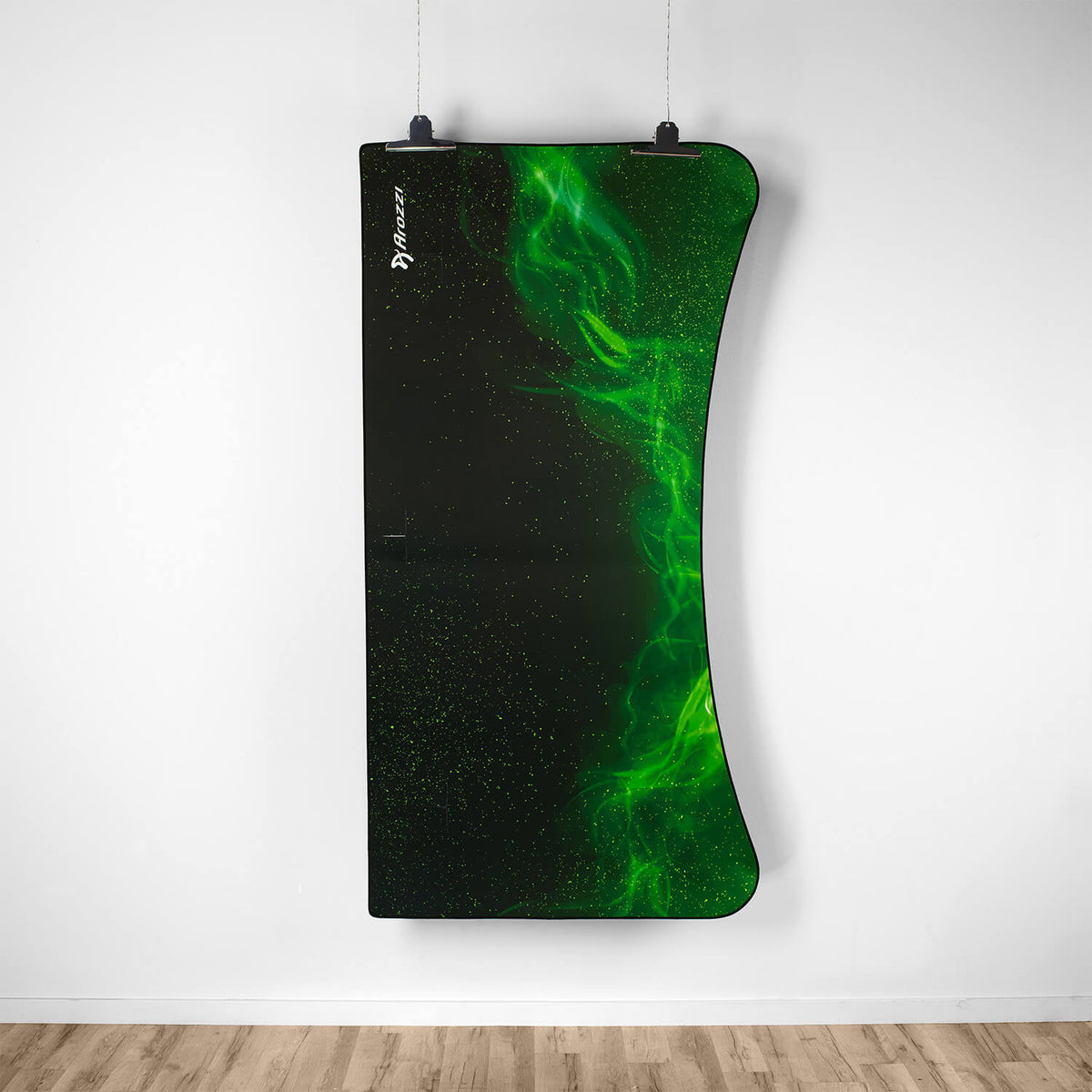 Curved black and green Arozzi Europe Arena Mousepad panel hangs above a white wood floor.