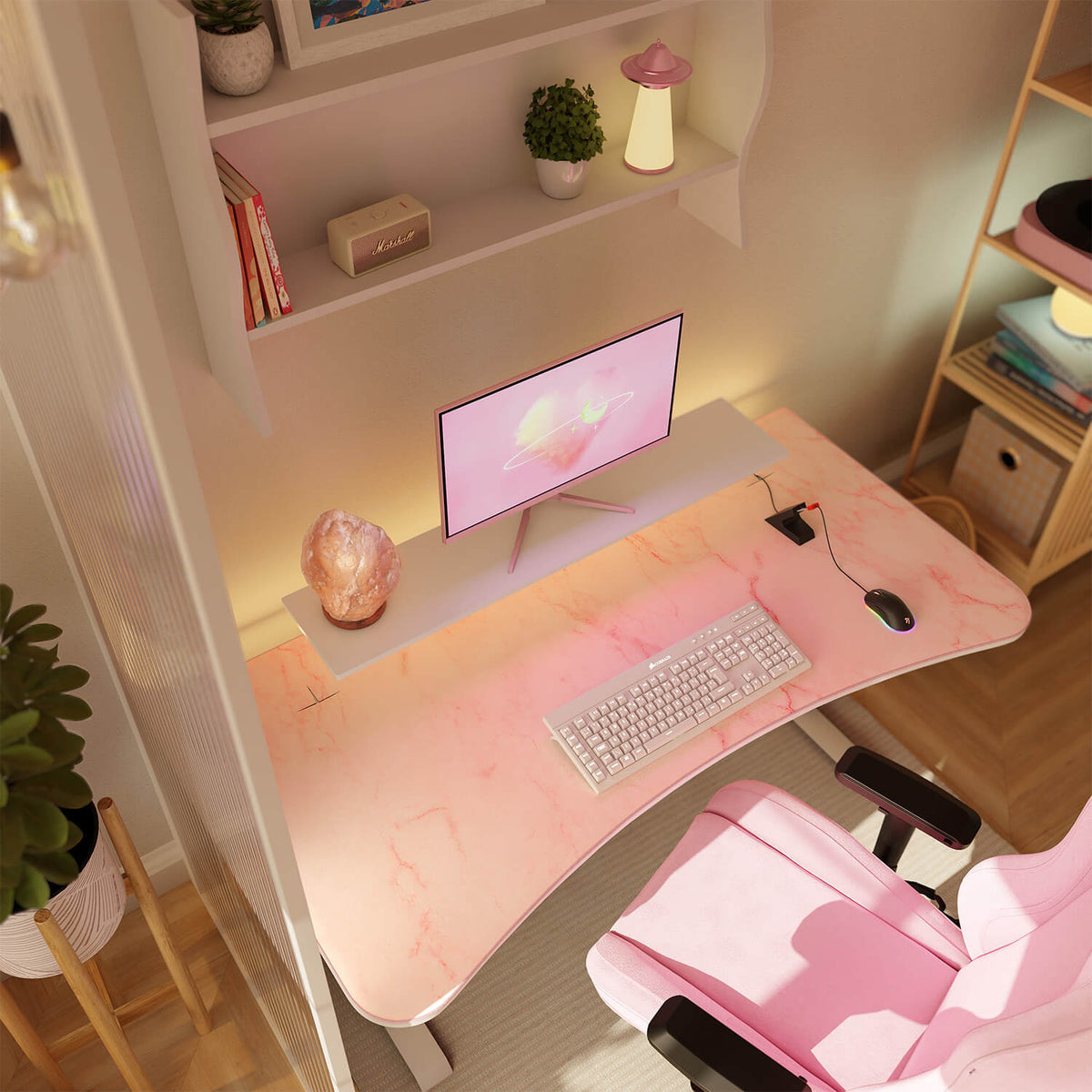 Pink desk setup: monitor, keyboard, Arozzi Arena mousepad, pink chair, and soft lighting.