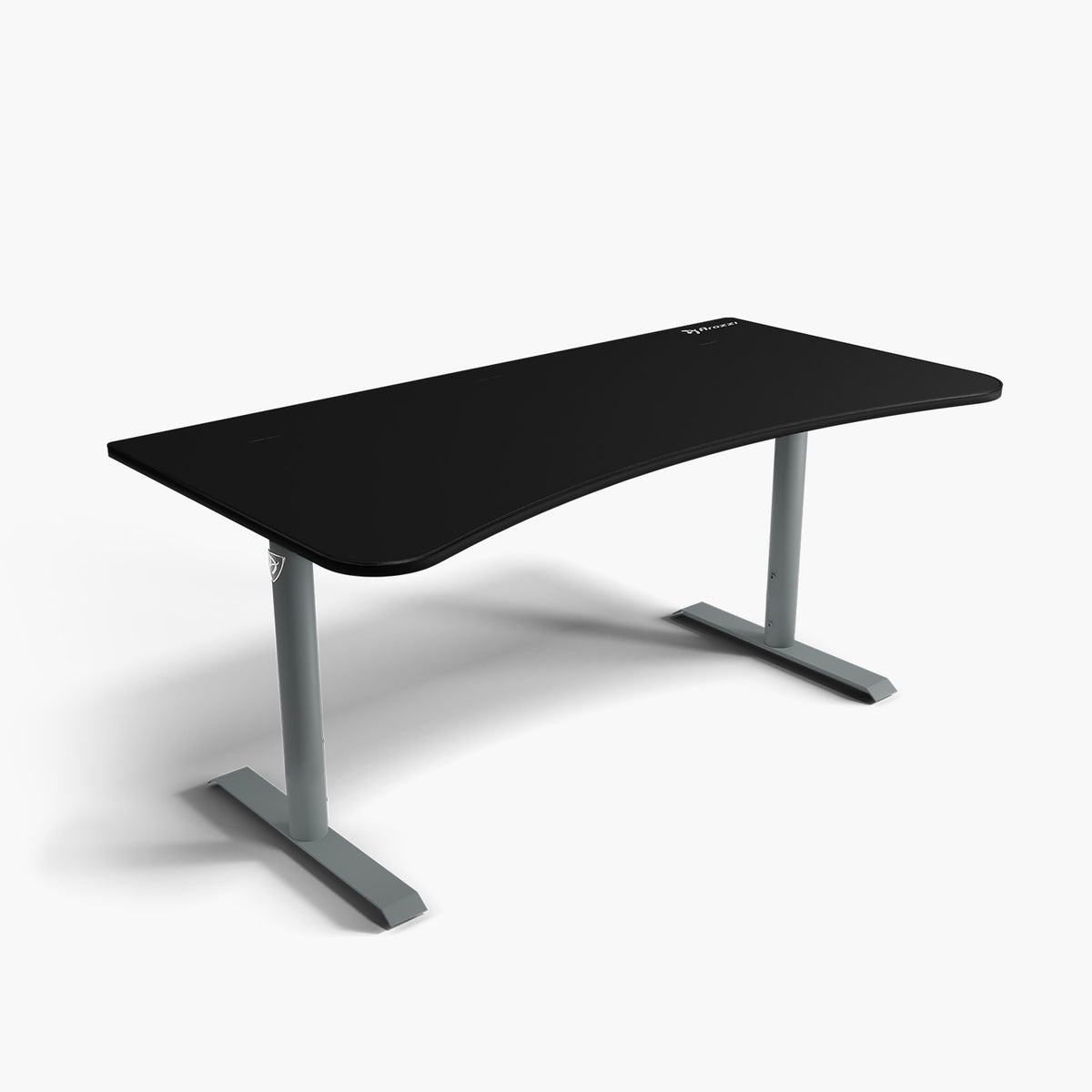 Arozzi Arena Large black curved gaming desk w/ gray legs & cable mgmt, shown on white.