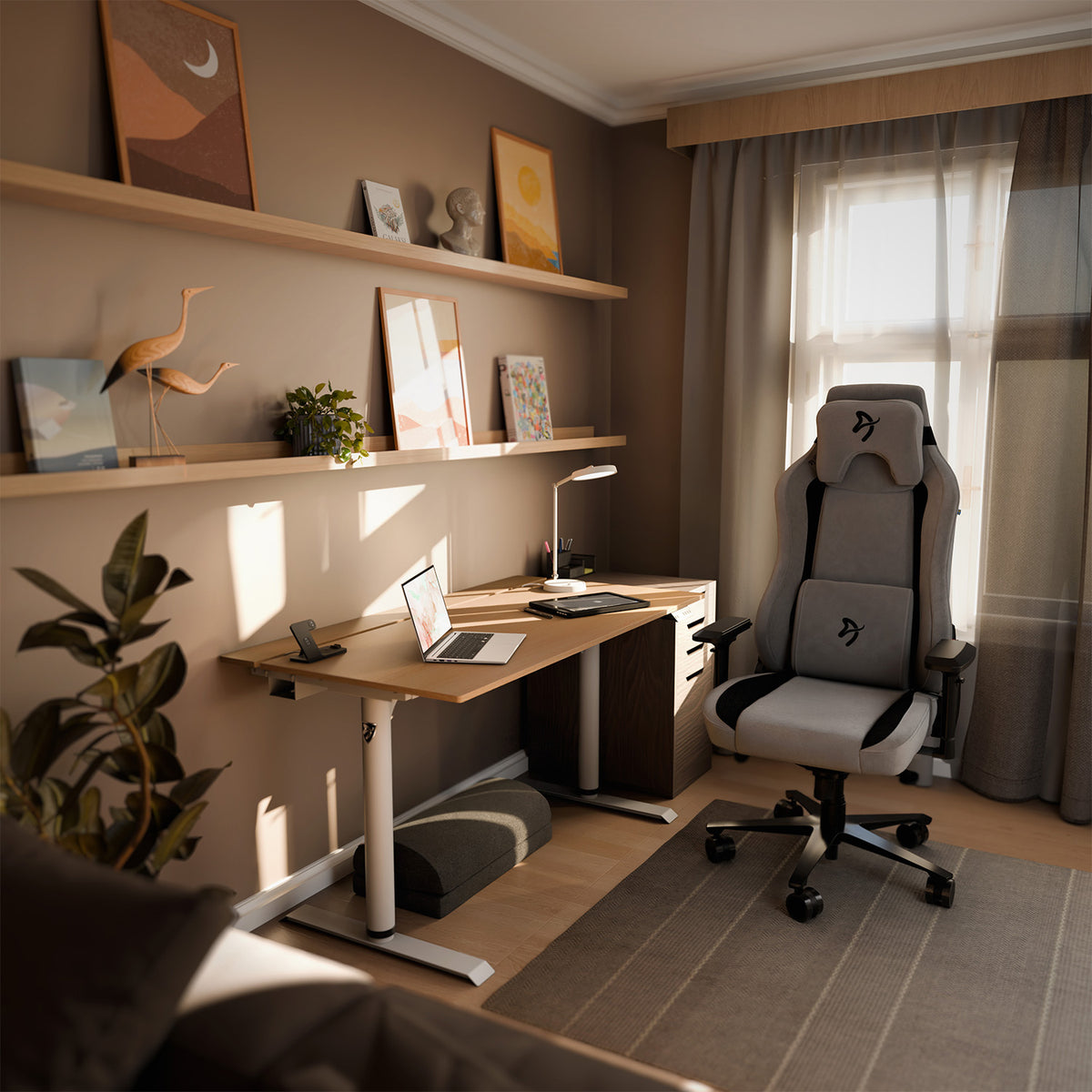 A modern office with an Arozzi Arena Nordico standing desk, laptop, plants, and wall art.