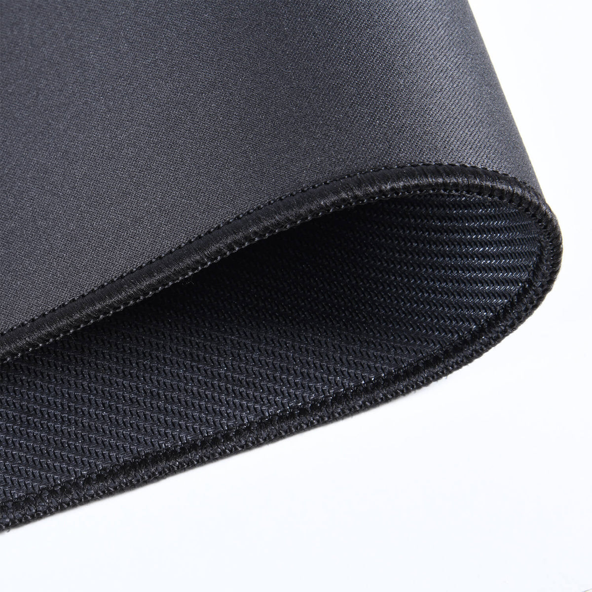 A close-up of a rolled black neoprene fabric with visible textured edges.