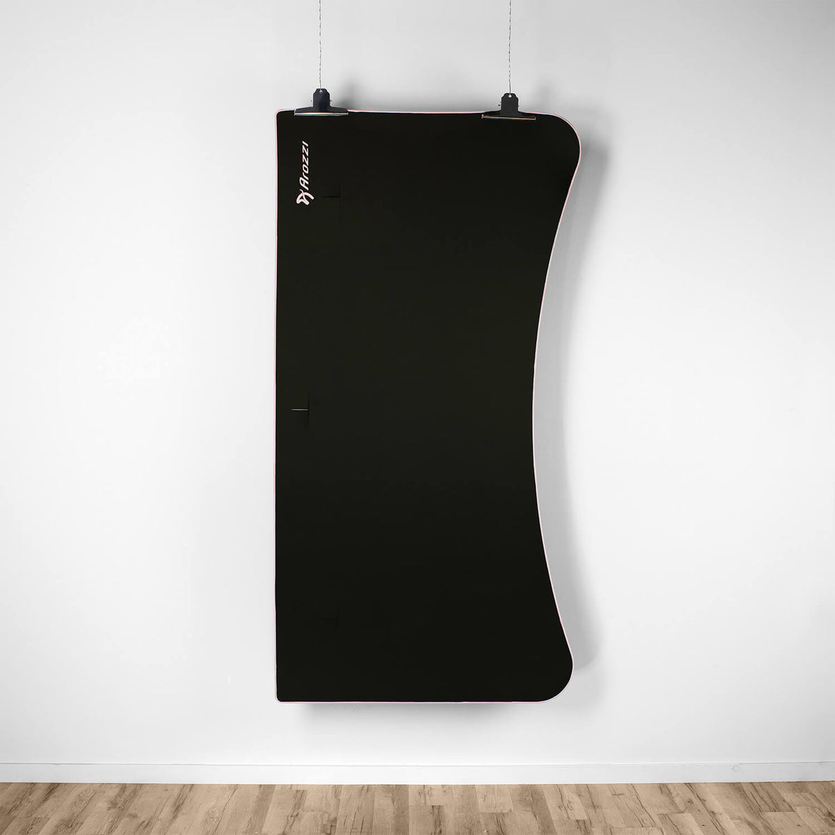 Curved black cabinet, white wall, wooden floor, and Arena Mousepad by Arozzi Europe on desk.