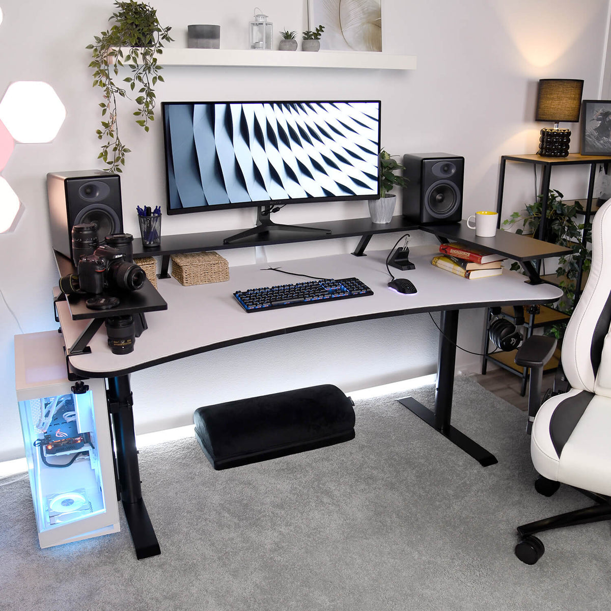 Arozzi Europe Desk Riser - Small setup with monitor, speakers, cameras, keyboard, and chair.