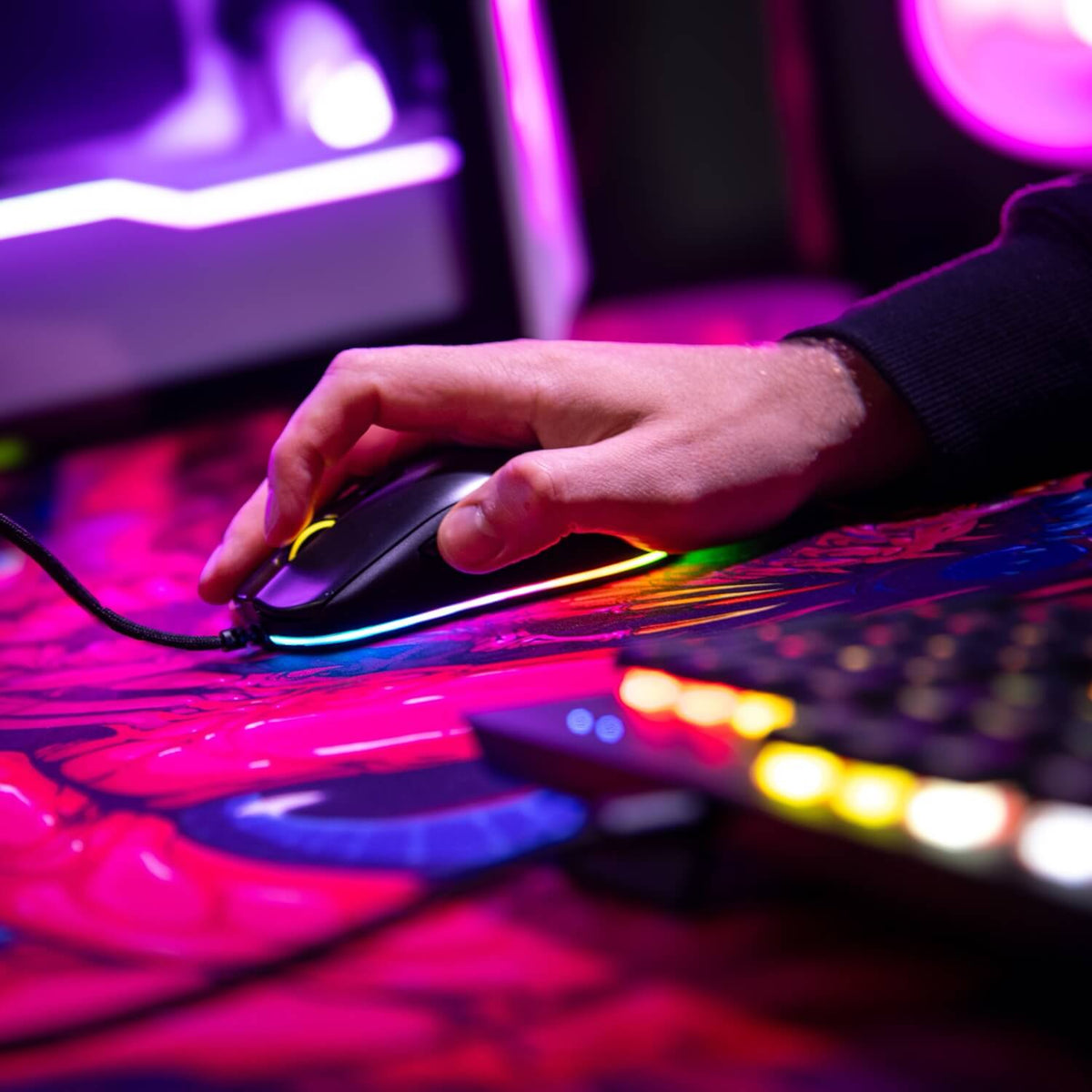 Favo 2 Ultra Light Gaming Mouse by Arozzi Europe beside a colorful backlit keyboard.