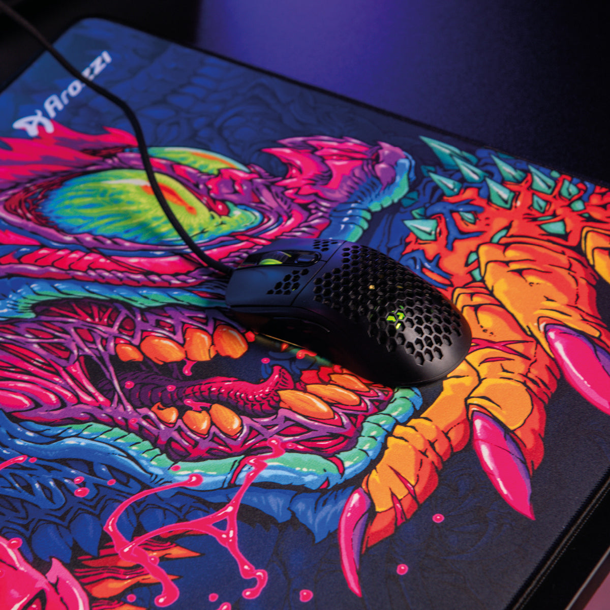 A black mouse on an Arozzi Europe Zona Mousepad - Extra Large with a dragon-inspired design.