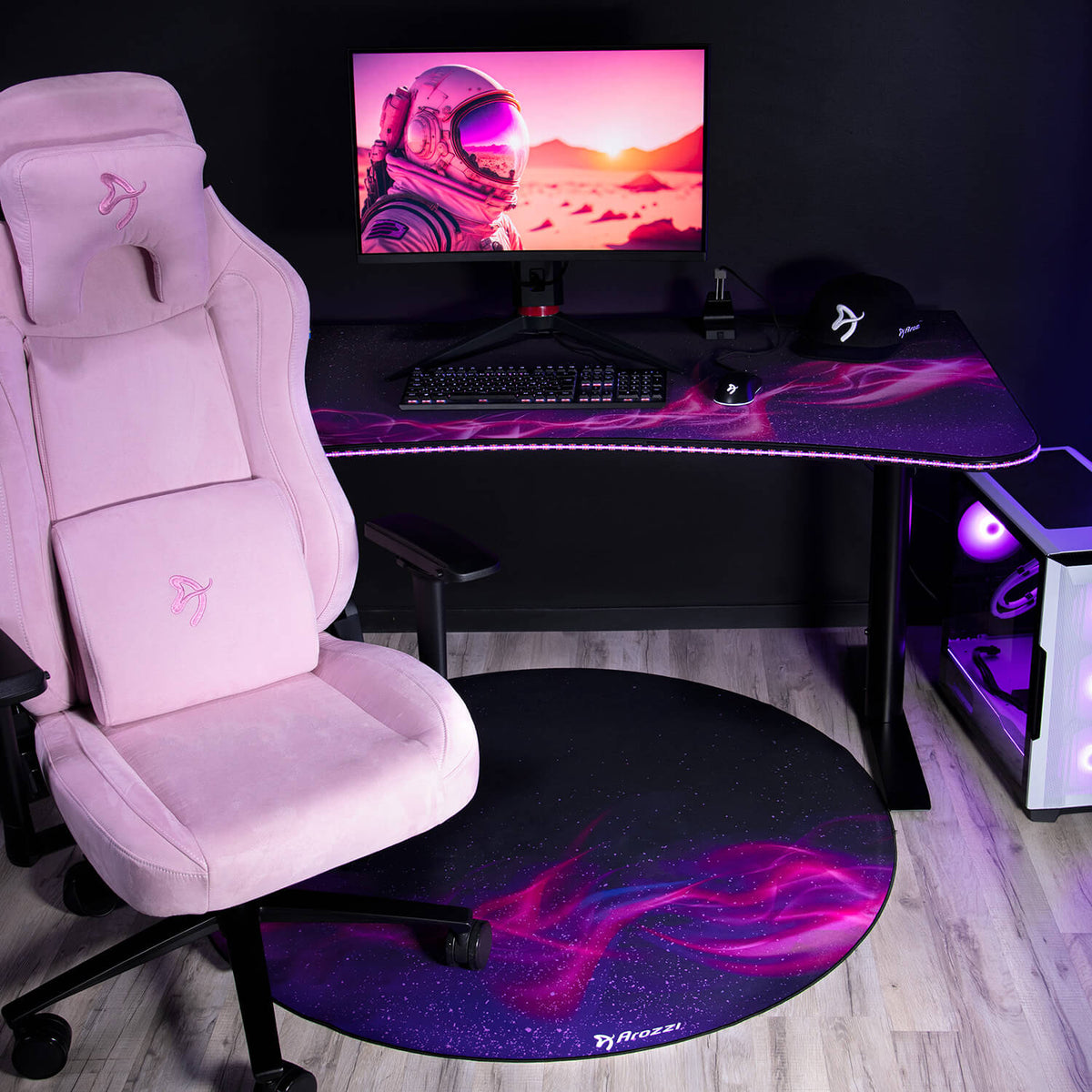 Arozzi Zona Round Floor Pad, pink gaming chair, mousepad, astronaut monitor, stylish setup.