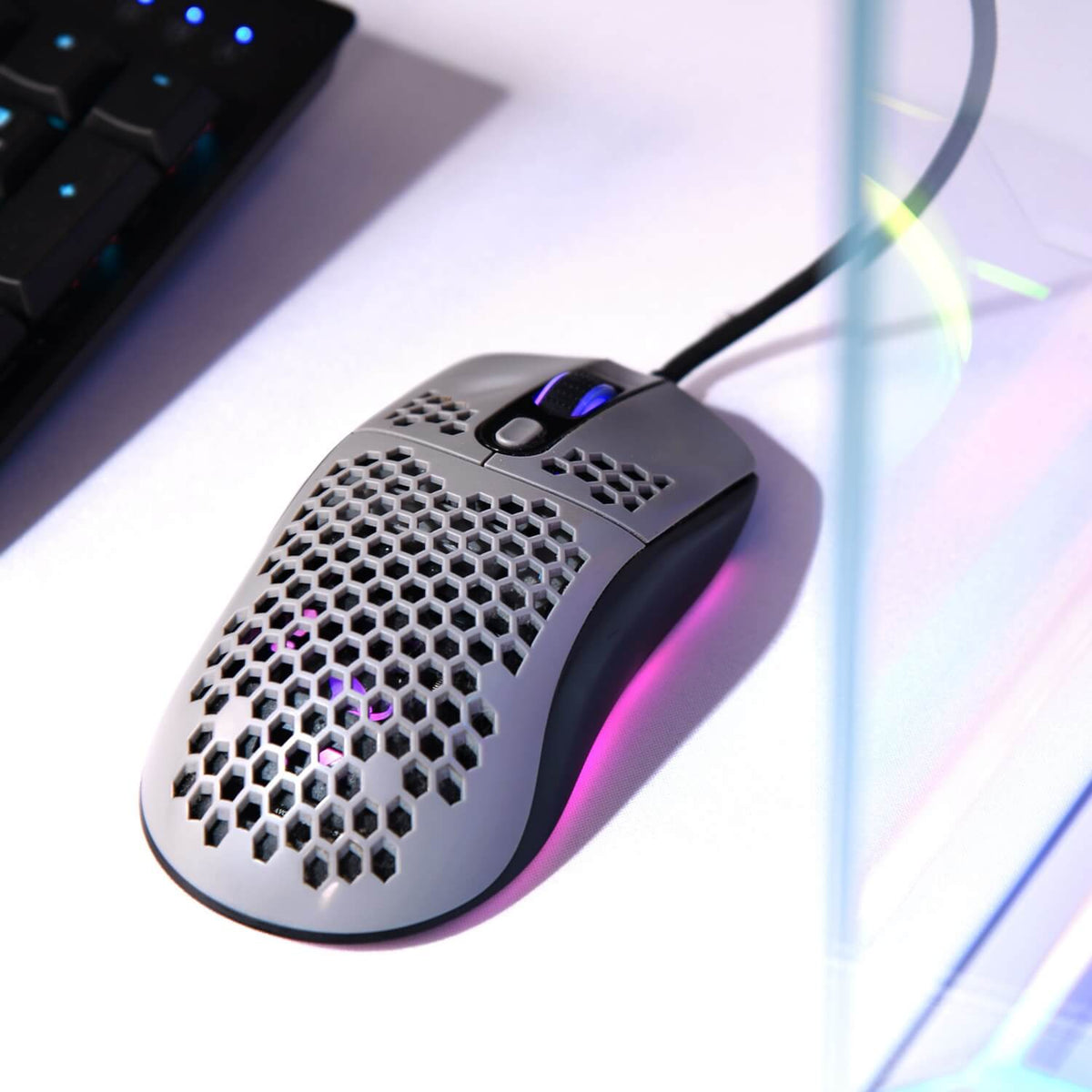 Arozzi Europe Favo Ultra Light Gaming Mouse with RGB and Pixart 3389 on white desk.