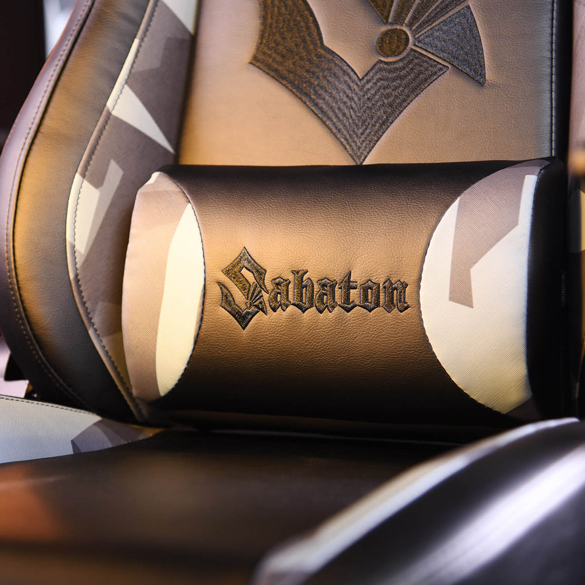 Black gaming chair with Sabaton text on a lumbar pillow, featuring patterned upholstery.
