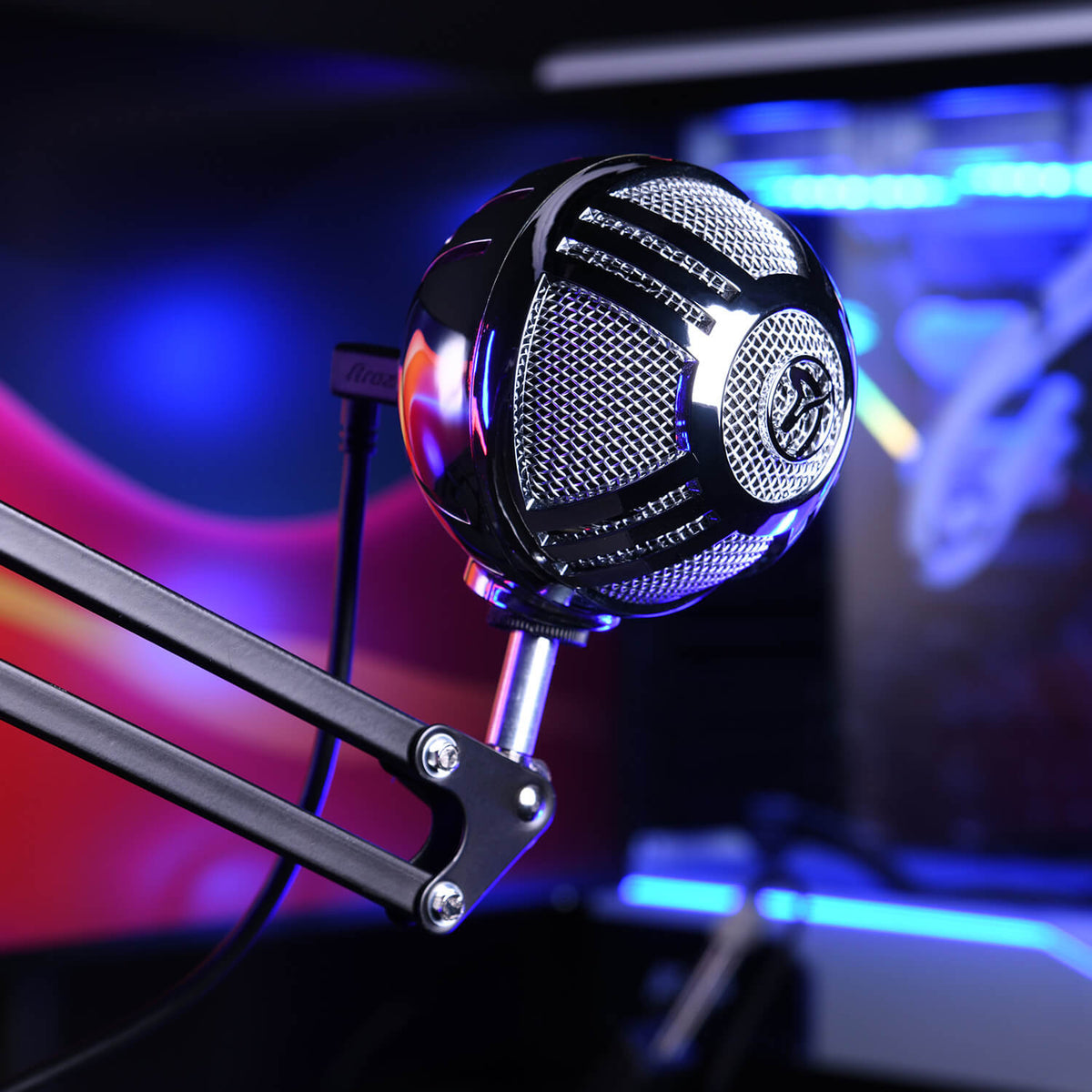 A spherical USB microphone on a boom arm, with colorful lights in the background.