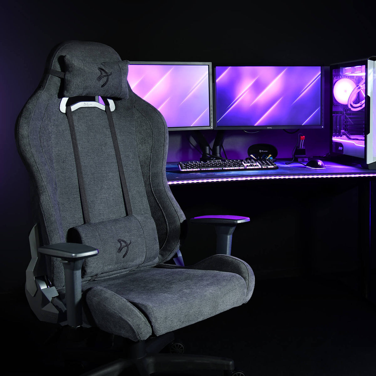 Arozzi Europe Torretta Soft Fabric chair with lumbar support at a dual monitor setup, purple lights.