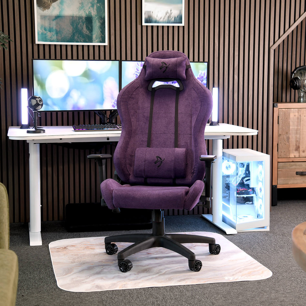 An Arozzi Europe Torretta Soft Fabric chair with lumbar support sits at a desk with monitors.