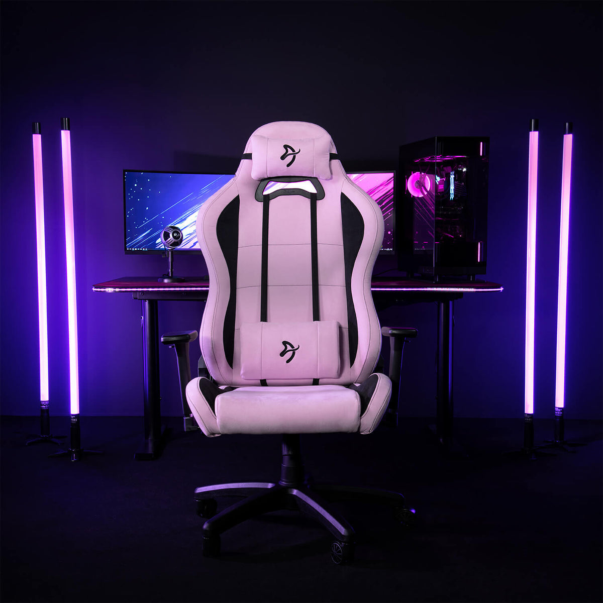 Arozzi Europe Torretta Supersoft chair with support pillows at a PC setup with purple LED lights.