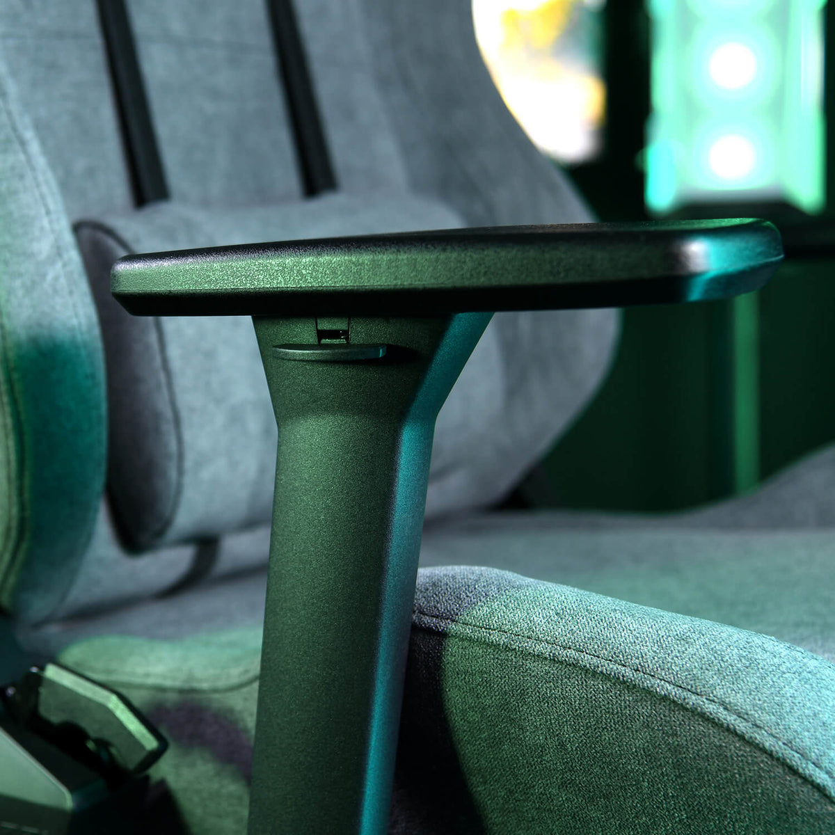 Close-up of a gray office chairs adjustable armrest in a modern setting.