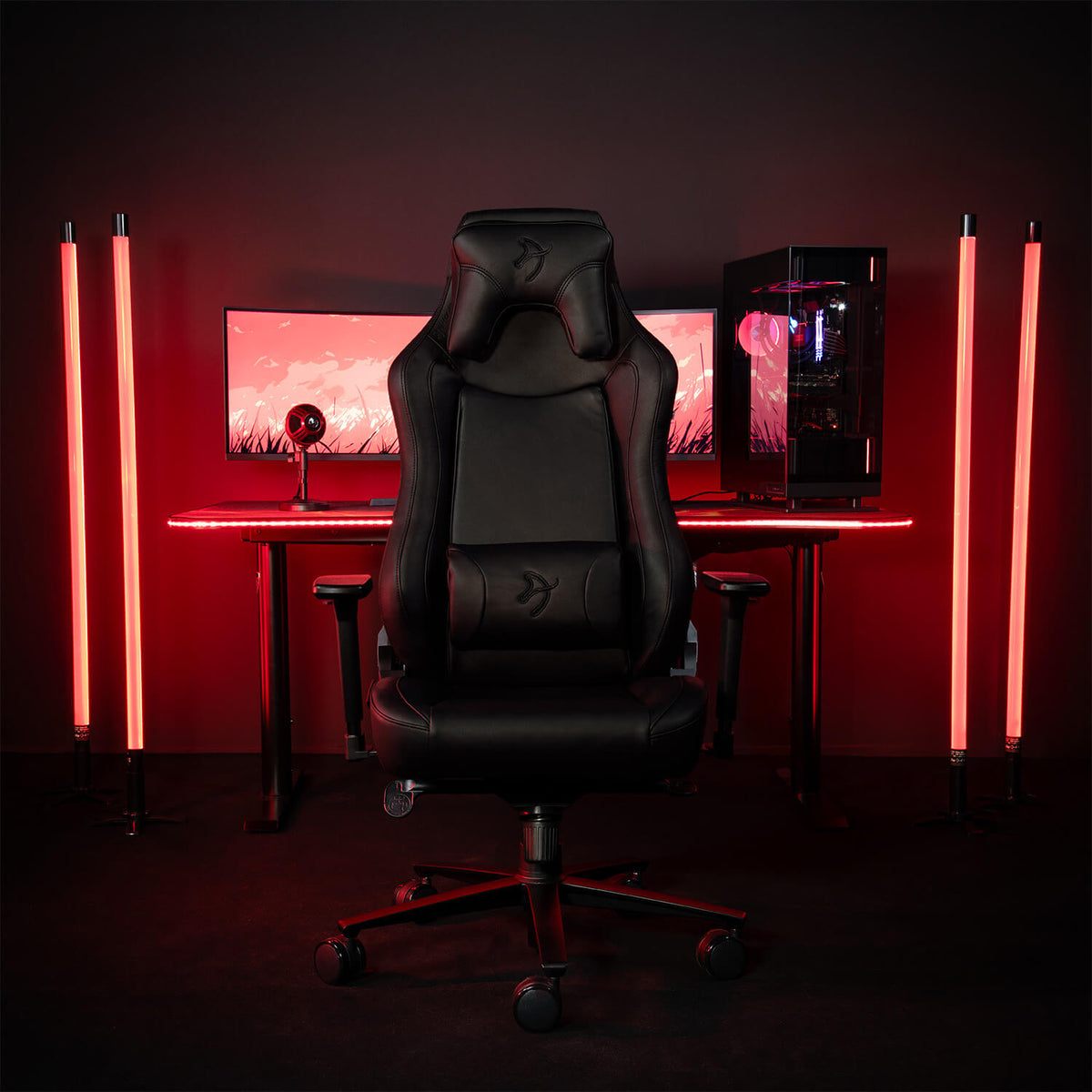 Arozzi Europe Vernazza SoftPU chair at a PC with red LEDs and four colorful light bars.