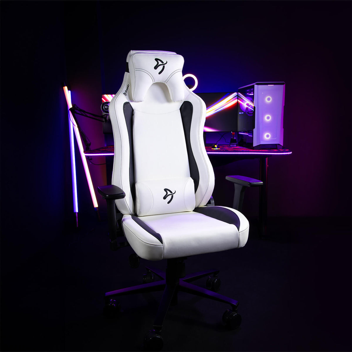 Arozzi Europe Vernazza SoftPU chair in front of a neon-lit computer setup.