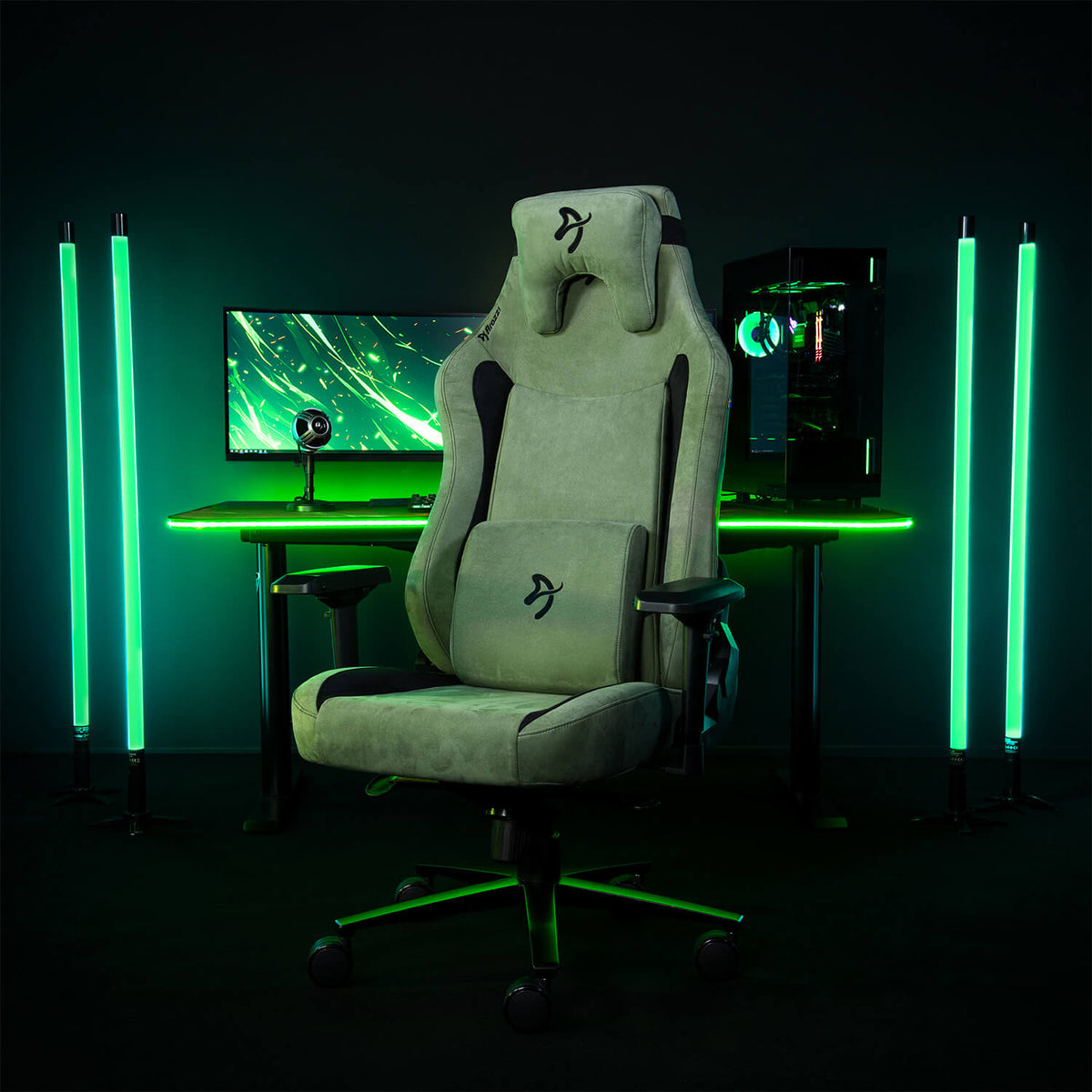 Arozzi Europe Vernazza XL Supersoft chair sits before a neon green-lit desktop setup.