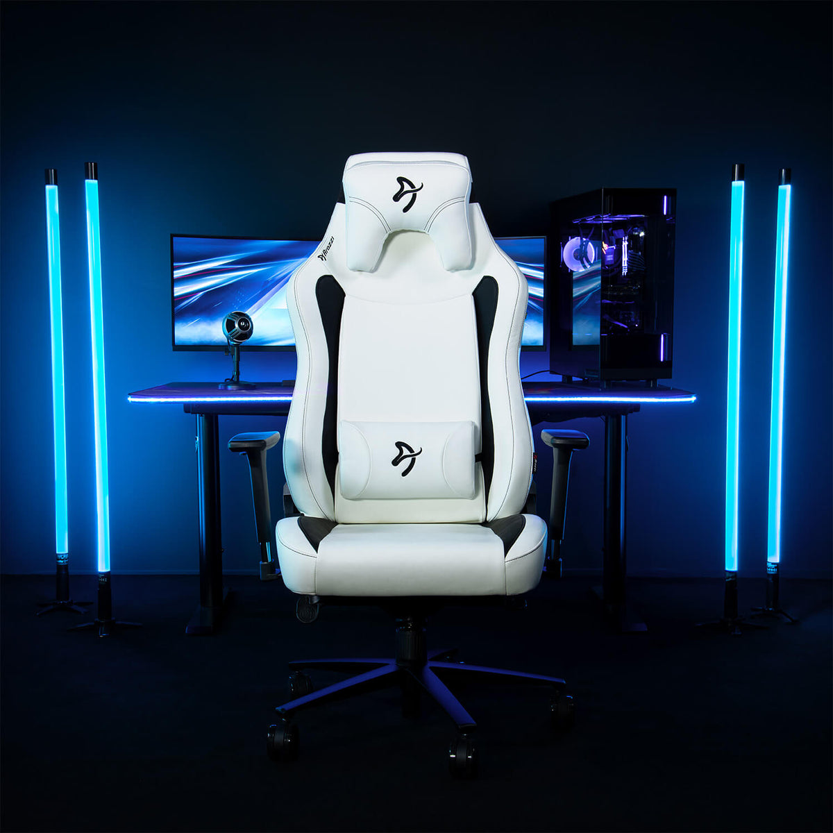 Arozzi Europe Vernazza XL SoftPU gaming chair with blue LED backlighting at a desk setup.