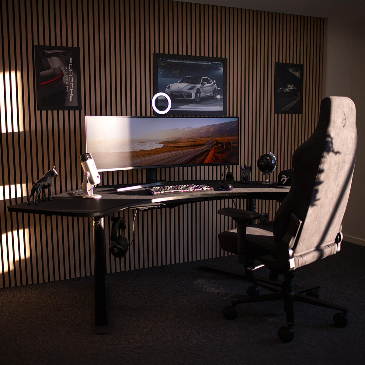 Arena Angelo corner desk by Arozzi Europe, curved monitor, ergonomic chair, car posters on wall.