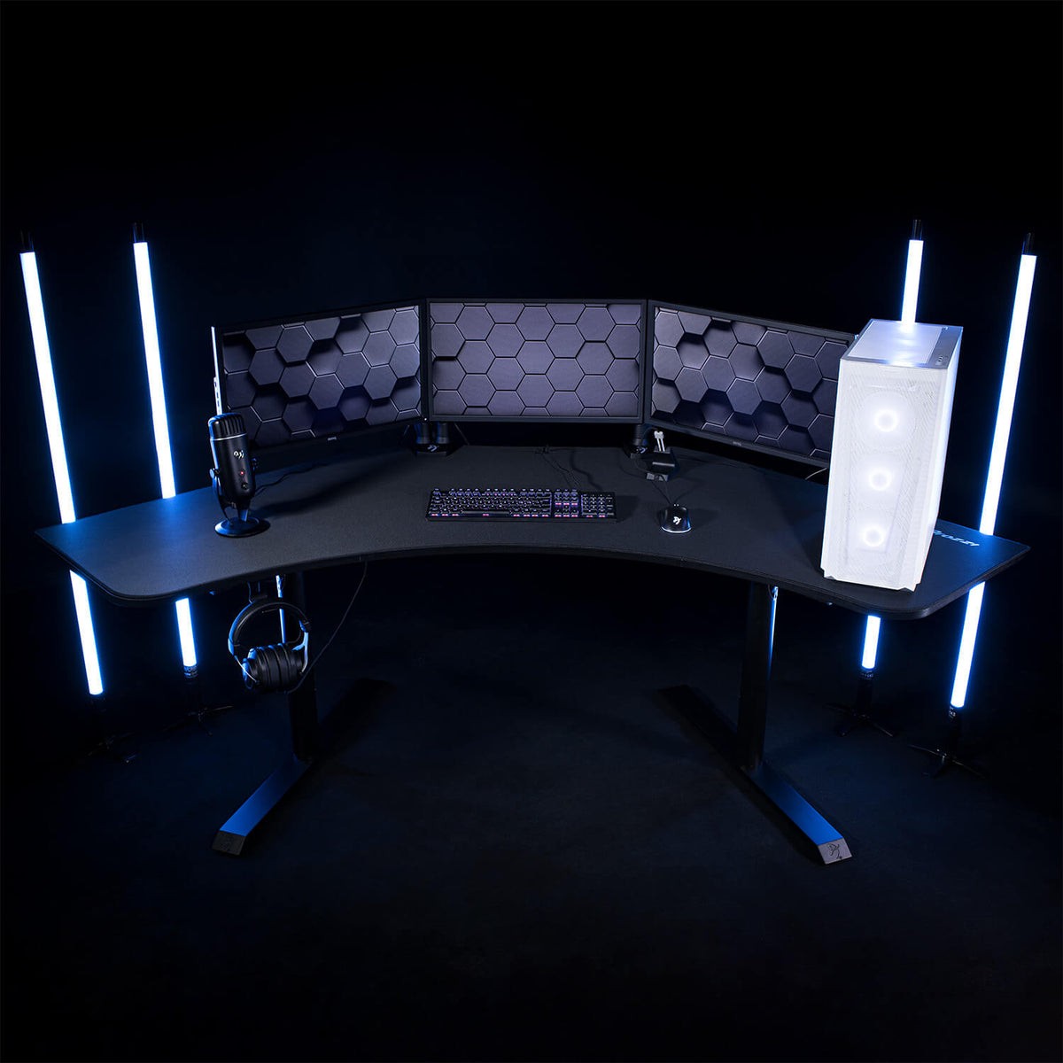 Arozzi Europe Arena Angelo desk with triple monitors, gaming gear, tower, keyboard & blue LEDs.
