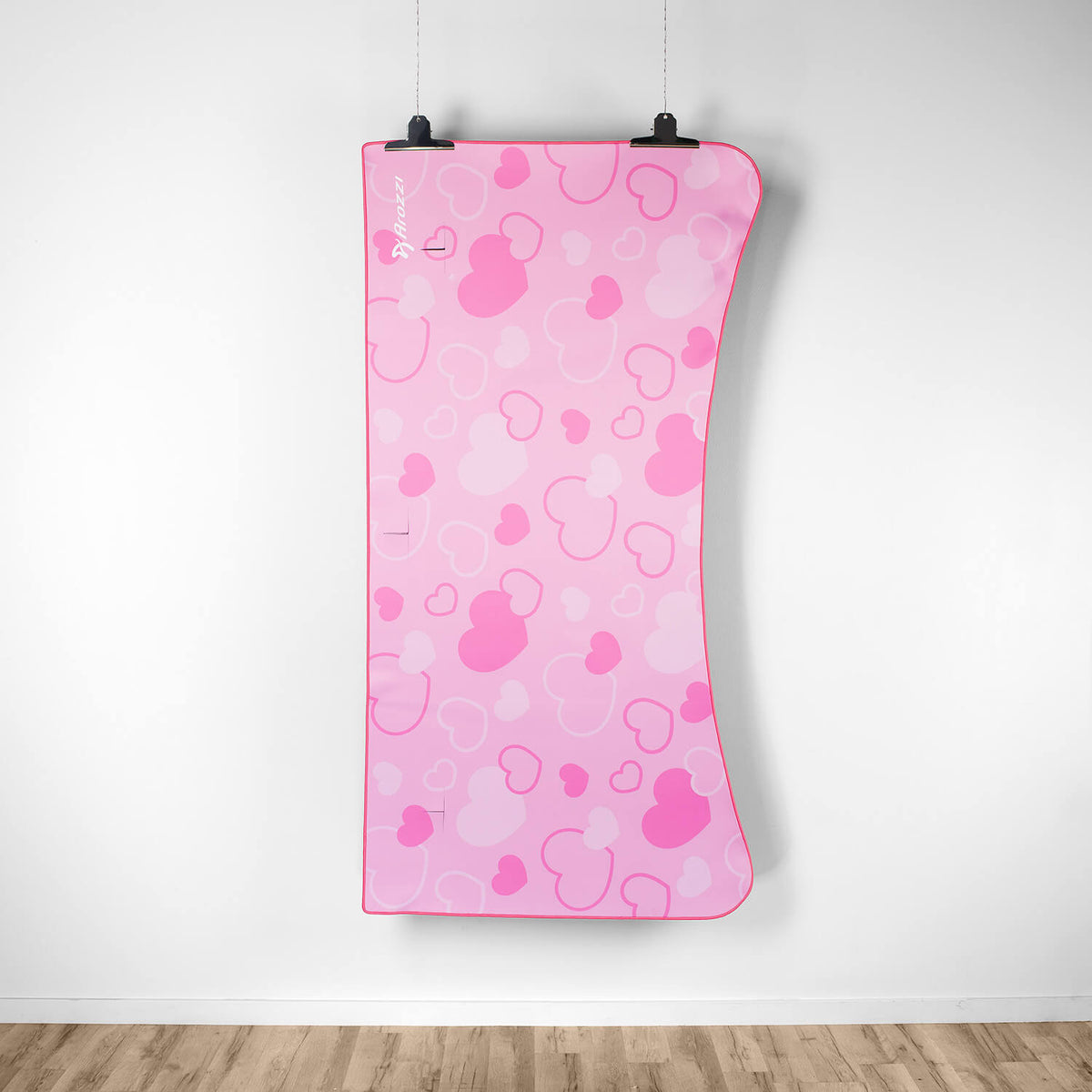 Arena Mousepad by Arozzi Europe, pink with heart and mouse head patterns, hangs on wall.