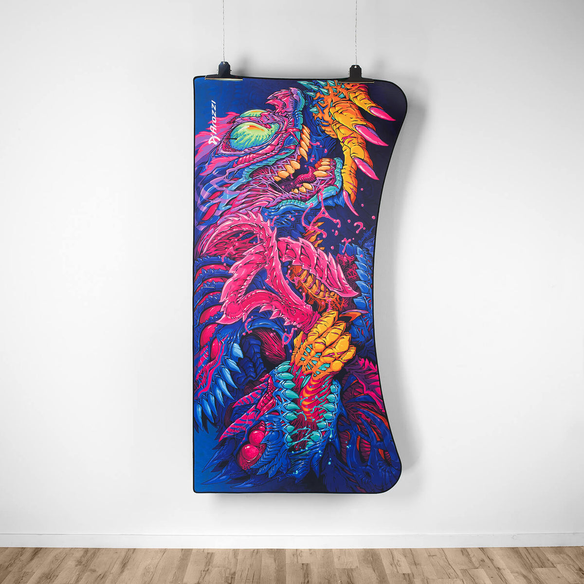 Arena Mousepad by Arozzi Europe with vibrant abstract dragon art displayed on a white wall.