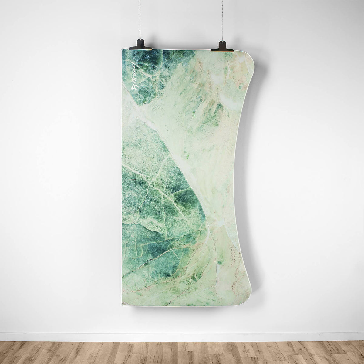 Curved green marble slab, like an Arozzi Europe Arena Mousepad, hangs on a white wall.