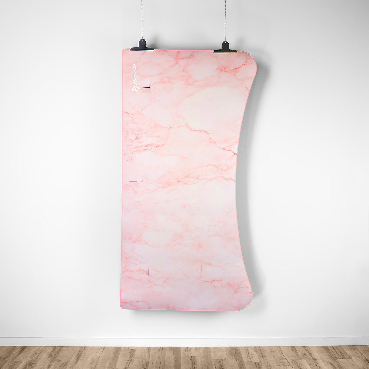 Curved pink marble wall panel above wood floor, pairs well with Arozzi Europe Arena Mousepad.