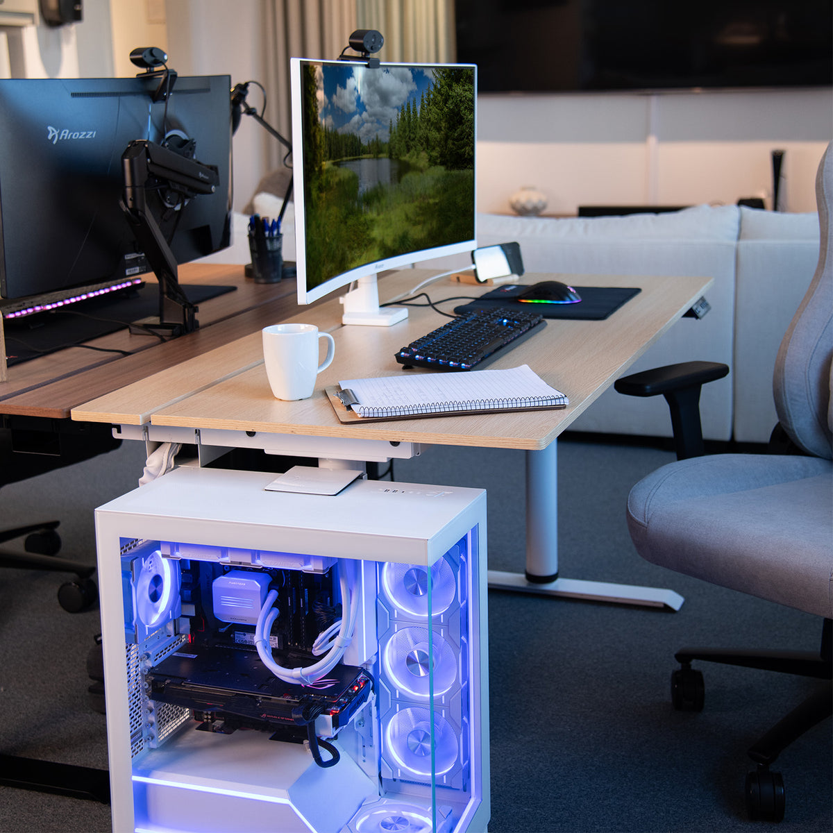Ergonomic workspace with Arena Nordico Electric Standing Desk by Arozzi Europe and blue-lit PC.