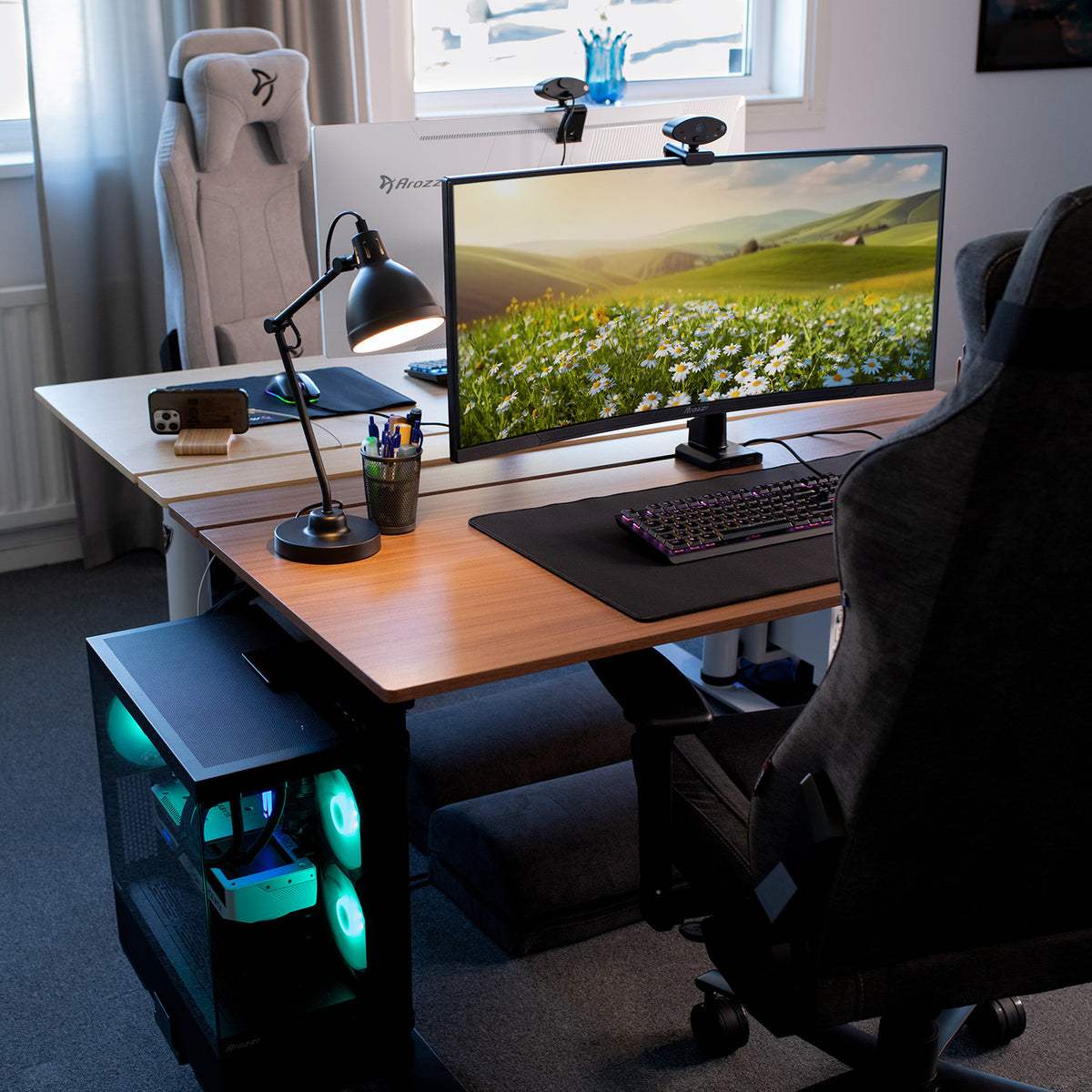 Dual desk setup with gaming chairs, PCs, and Arozzi Zona Extra Large Mousepad by a field display.