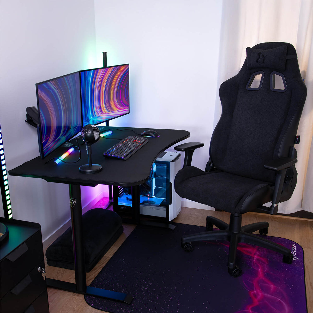 Arozzi Arena Gaming Desk - Small with black chair, dual monitors, keyboard, space-saving design.