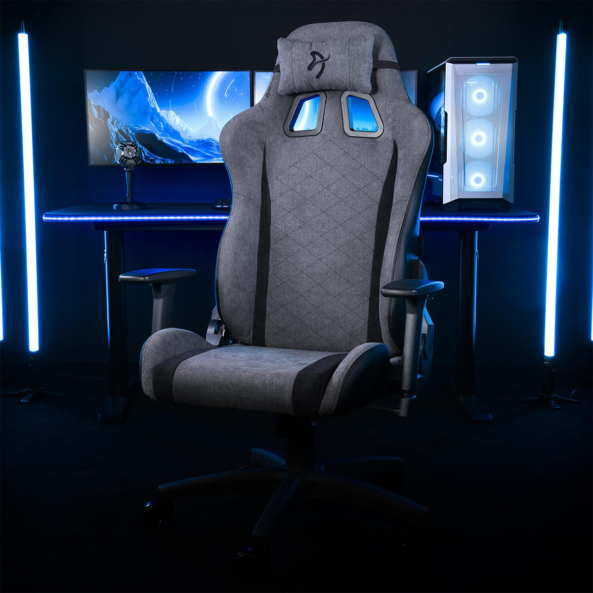 Arozzi Europe Avanti Soft Fabric chair with head pillow by desk and blue LED lights.