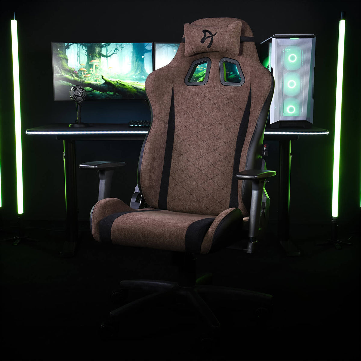 Arozzi Europe Avanti Soft Fabric chair in brown, with head pillow, set before monitors and PC.