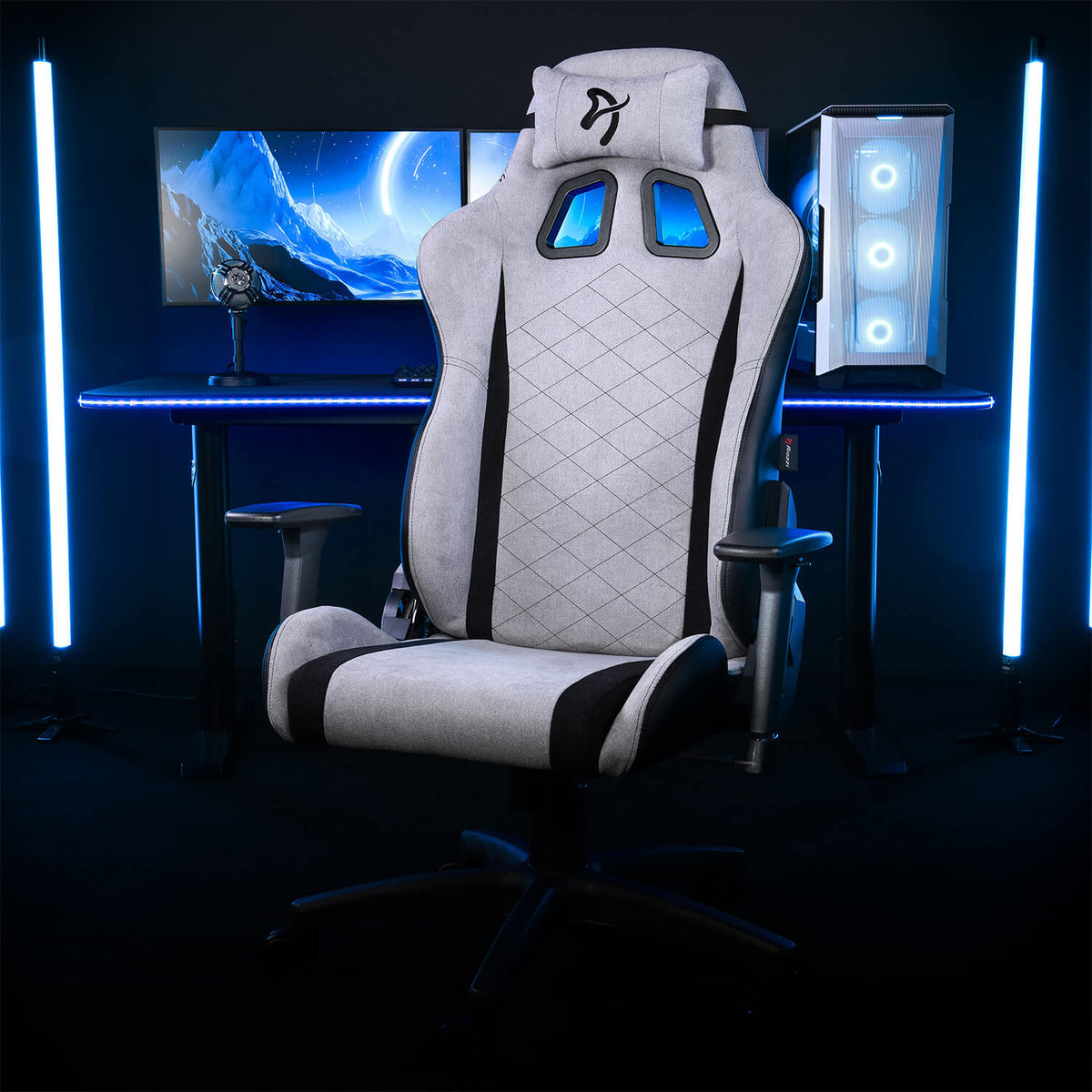 Arozzi Europe Avanti Soft Fabric chair with head pillow at desk, monitors, PC, and blue lighting.