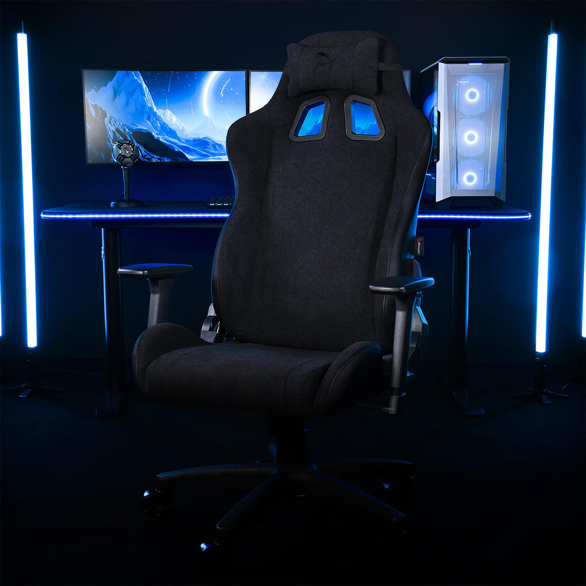 Arozzi Europe Avanti Soft Fabric chair with head pillow, at desk with monitors and blue LEDs.