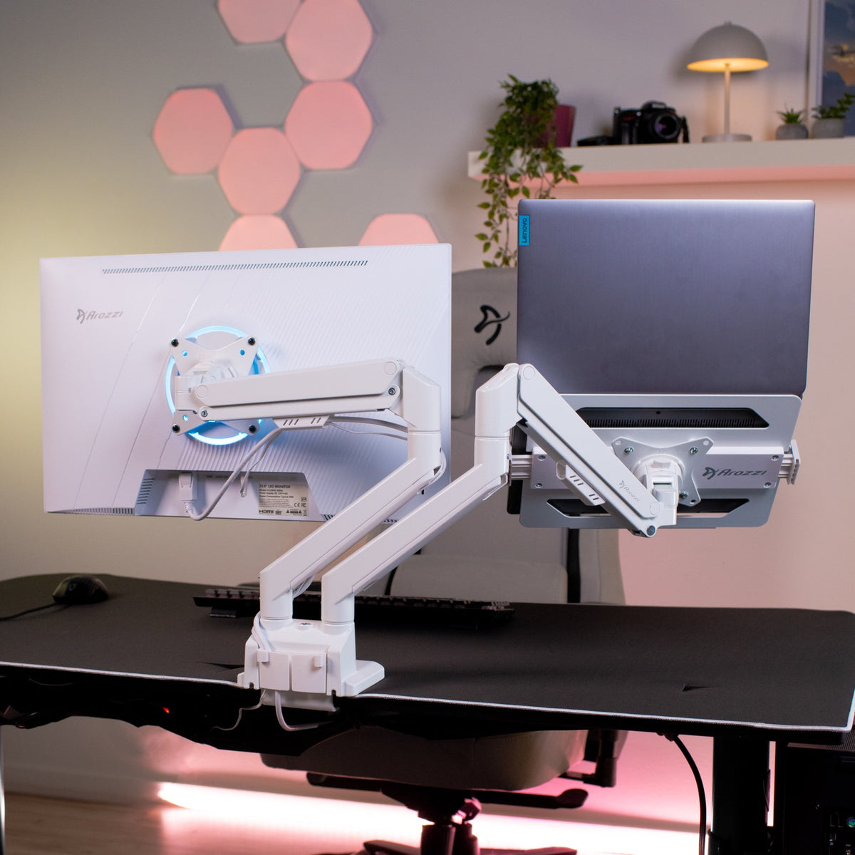 Alzare Laptop Holder by Arozzi Europe with dual monitors on ergonomic arms in a modern workspace.