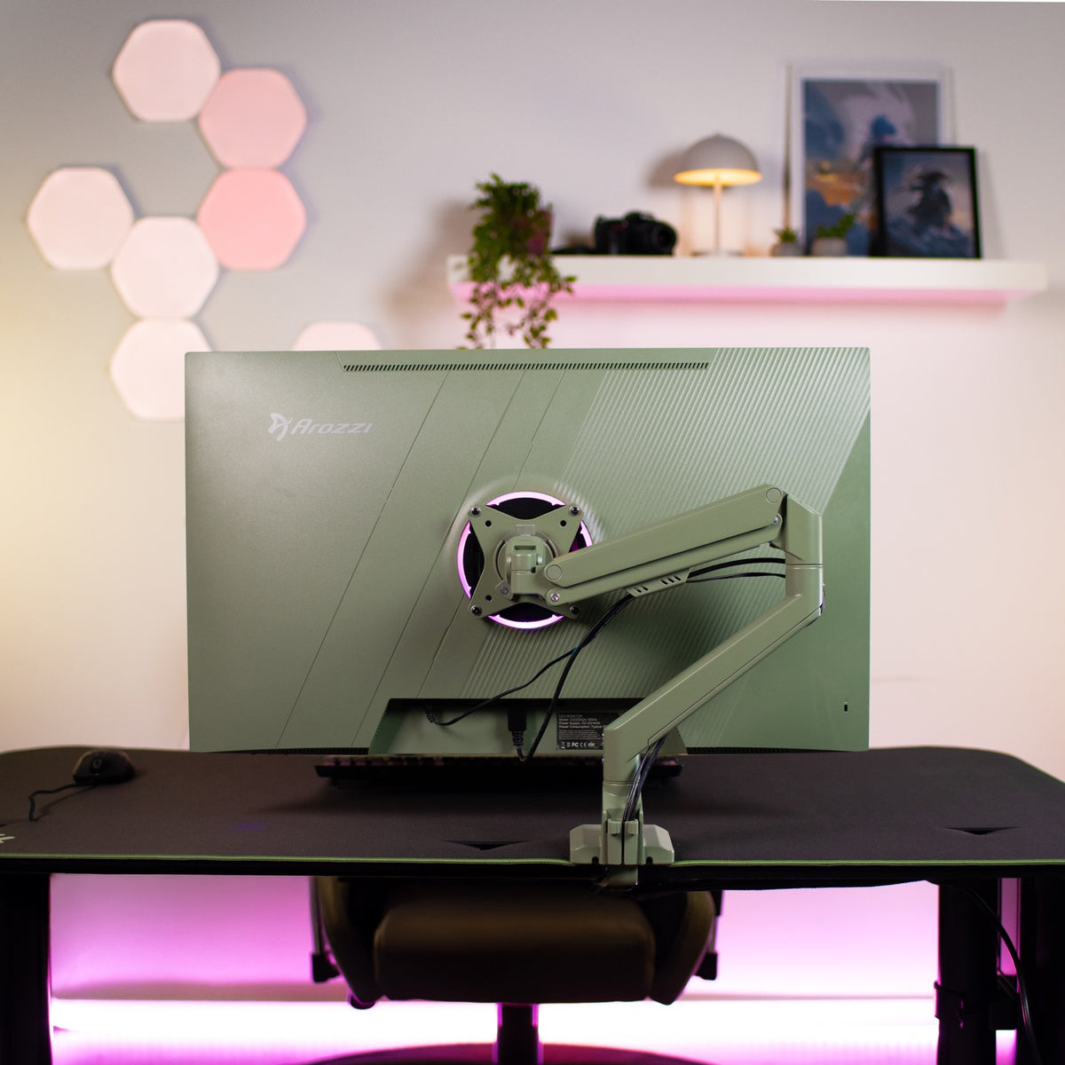 Green Arozzi Alzare Neo monitor on desk with Alzare Neo Single Gas Spring Arm, pink backlight.