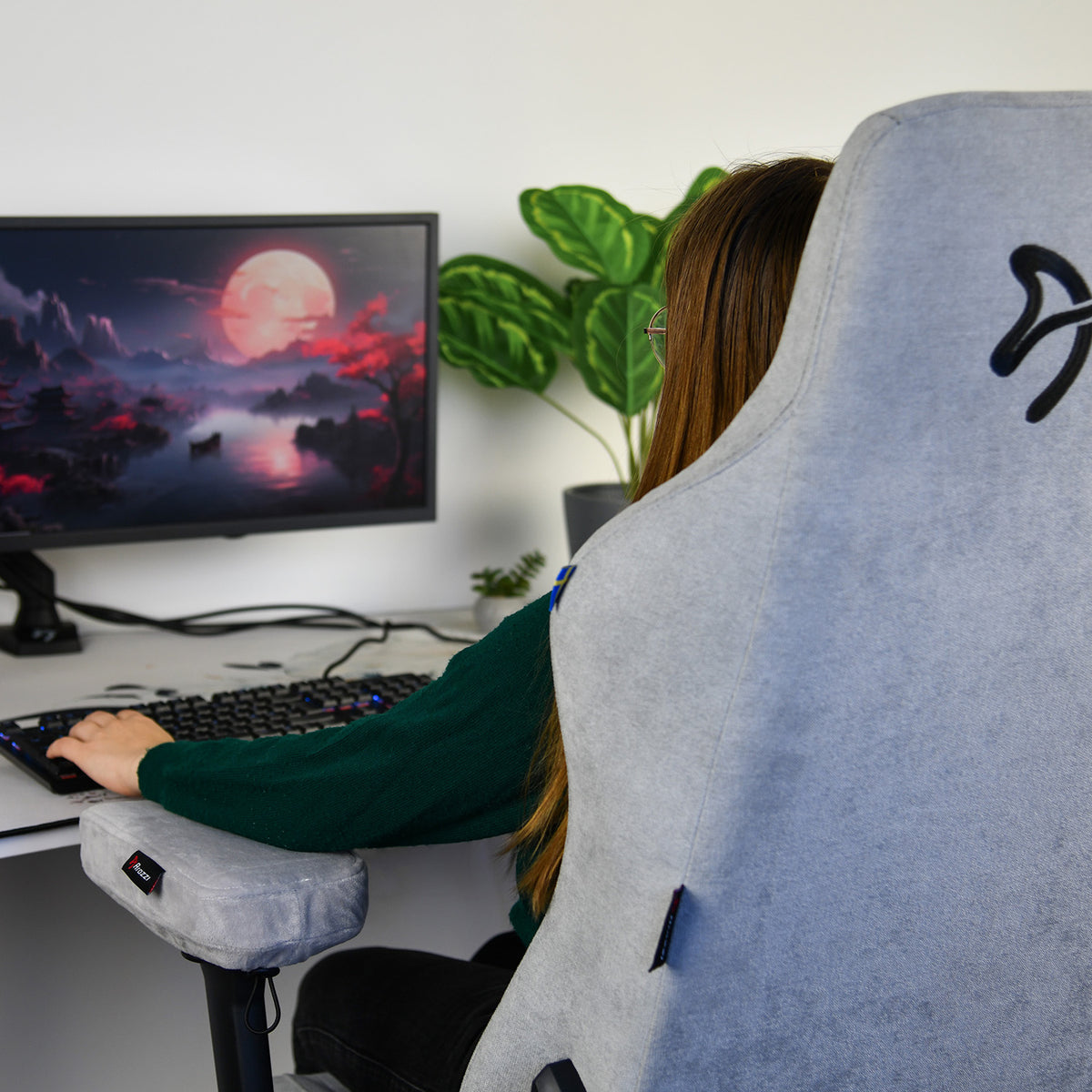 Person at desk on computer; Arozzi Europe Memory Foam Armrest Pads add moonlit-comfort.