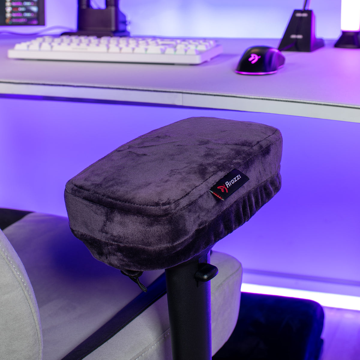 Arozzi Europe Memory Foam Armrest Pads on a gaming chair, glowing in purple desk lighting.