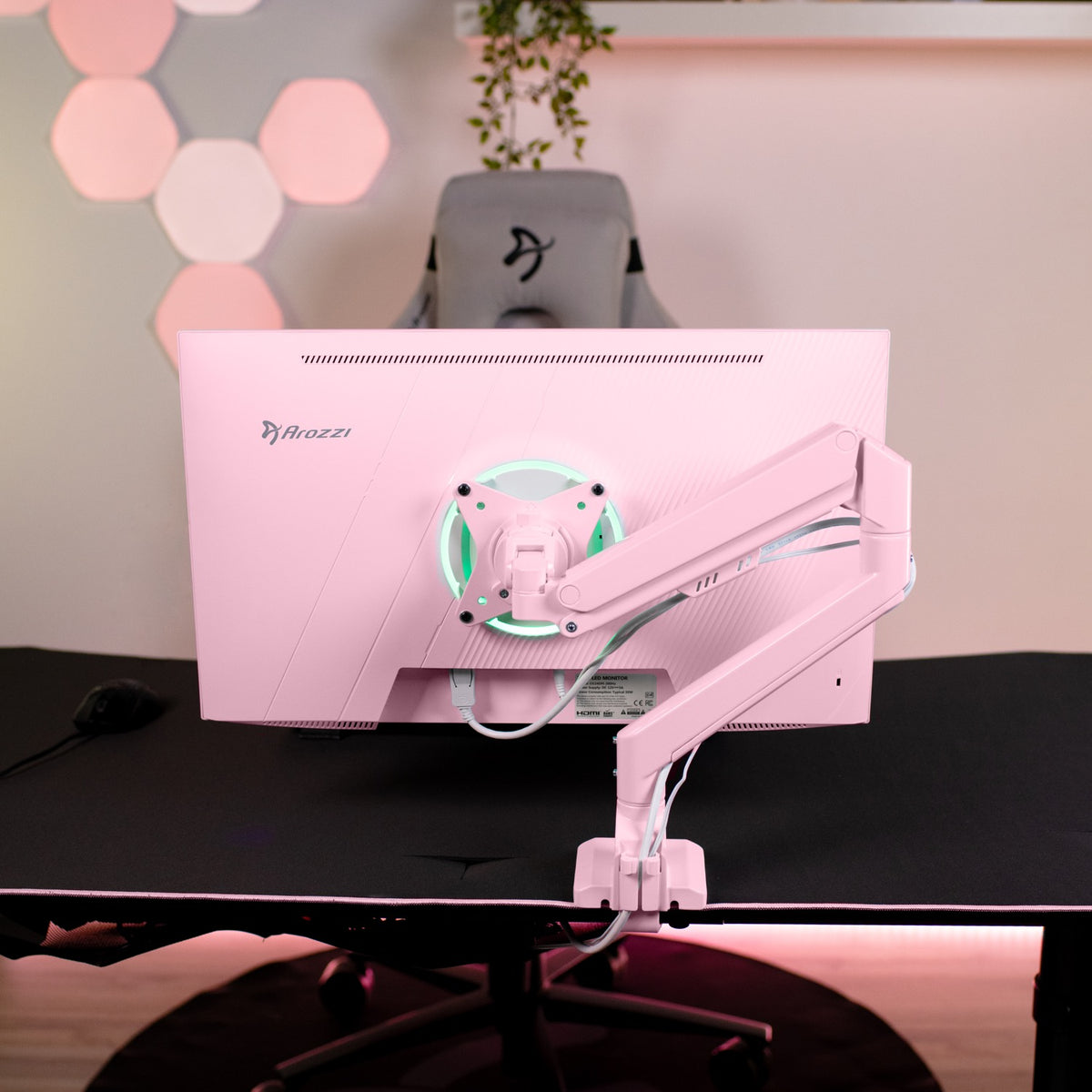 Arozzi Europe Nova 24″ IPS 200Hz gaming monitor in pink on an adjustable arm, rear view.