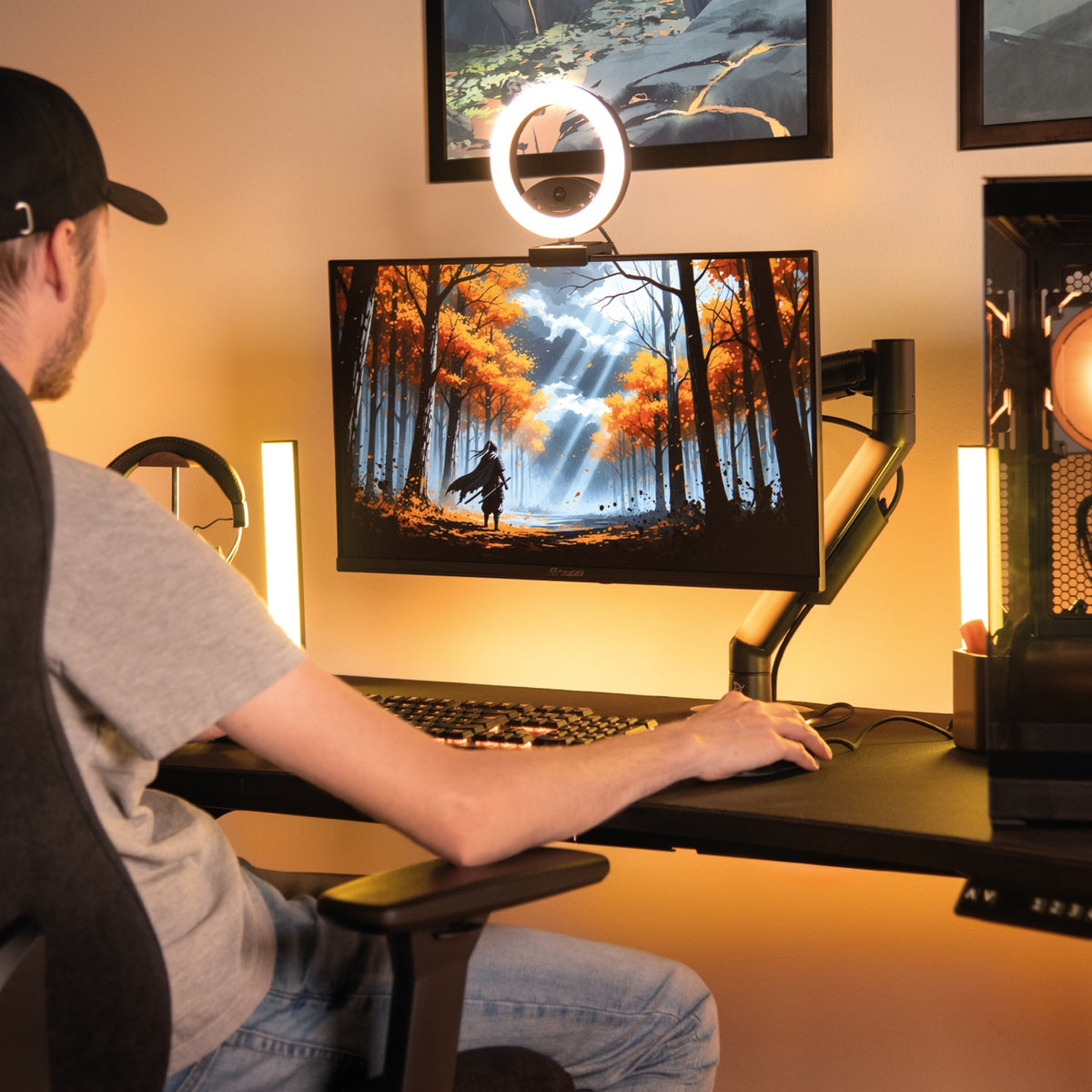 Gamer at desk using Arozzi Europe Nova 25″ E-sport IPS 400Hz monitor, autumn forest displayed.