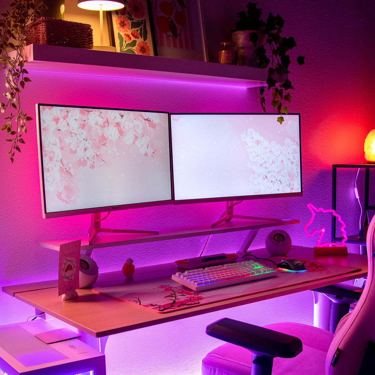 Dual Nova 27″ IPS 260Hz monitors by Arozzi Europe, pink LEDs, and unicorn decor on desk.