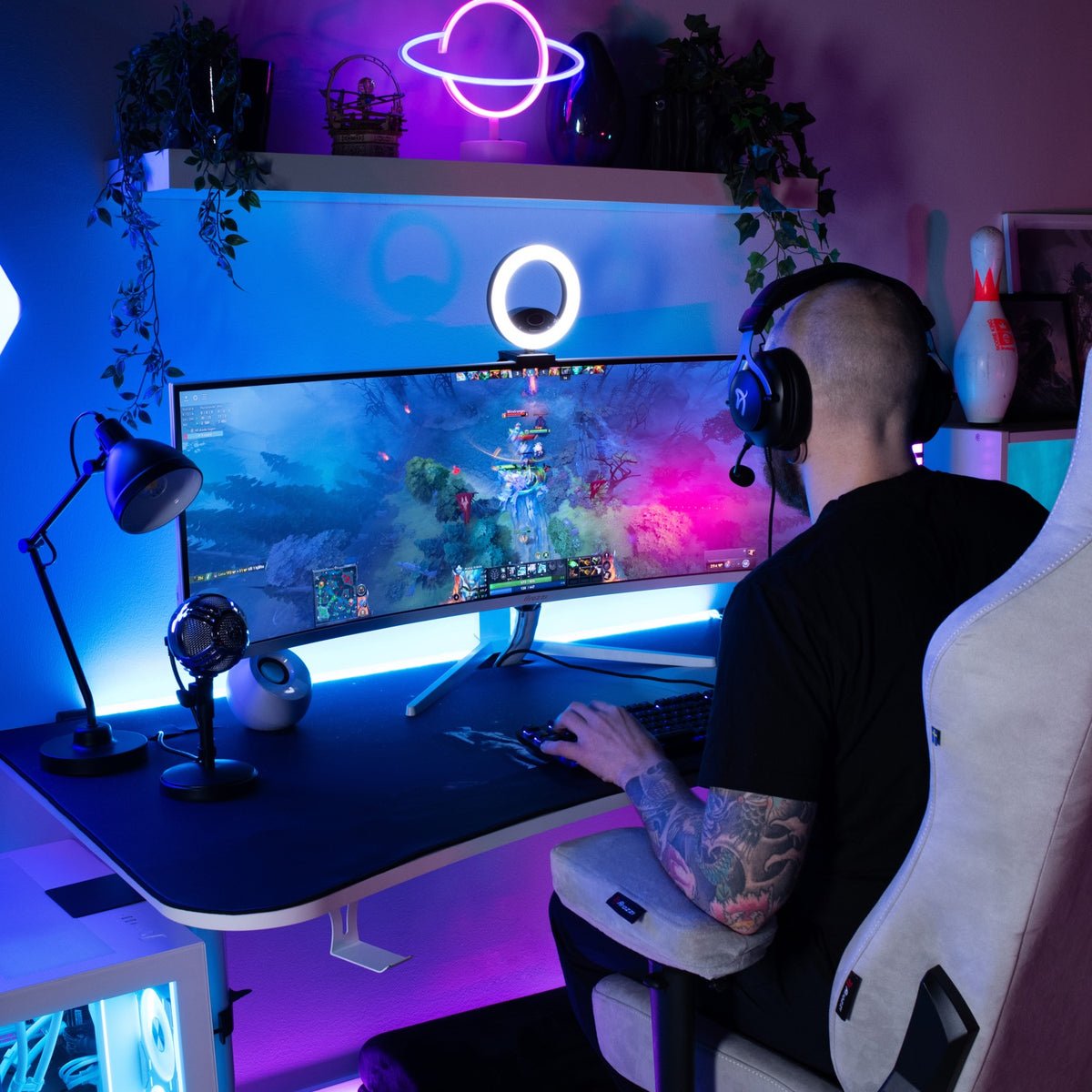 Person gaming at a Nova 49″ Curved VA 165Hz Ultrawide by Arozzi Europe with vibrant LED lighting.