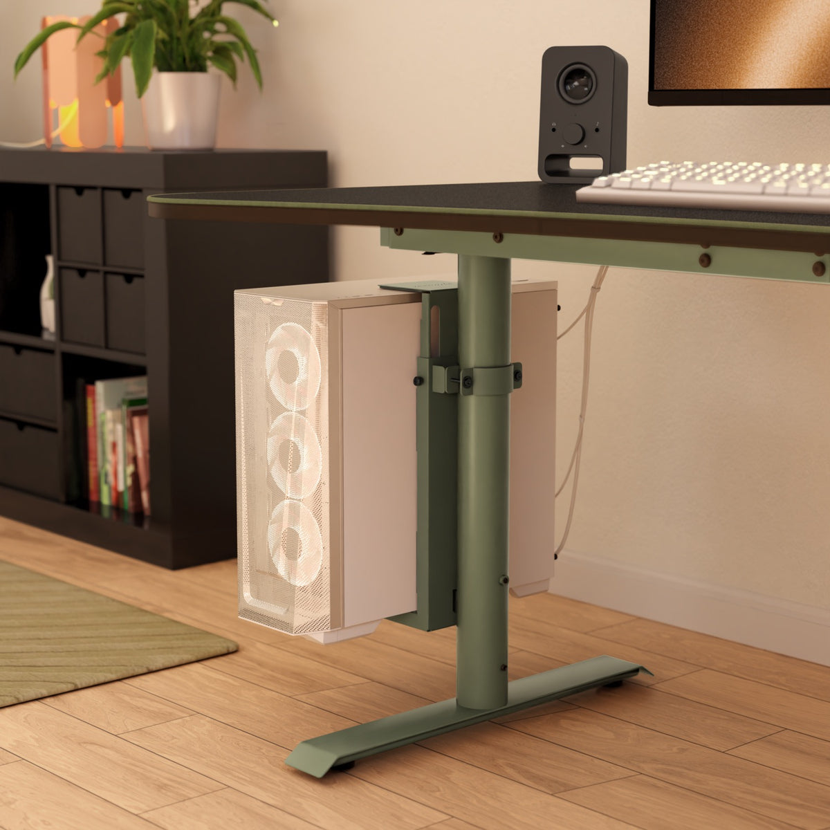 Arozzi Arena PC Mount holds a white 3-fan PC under a green desk in a modern room.