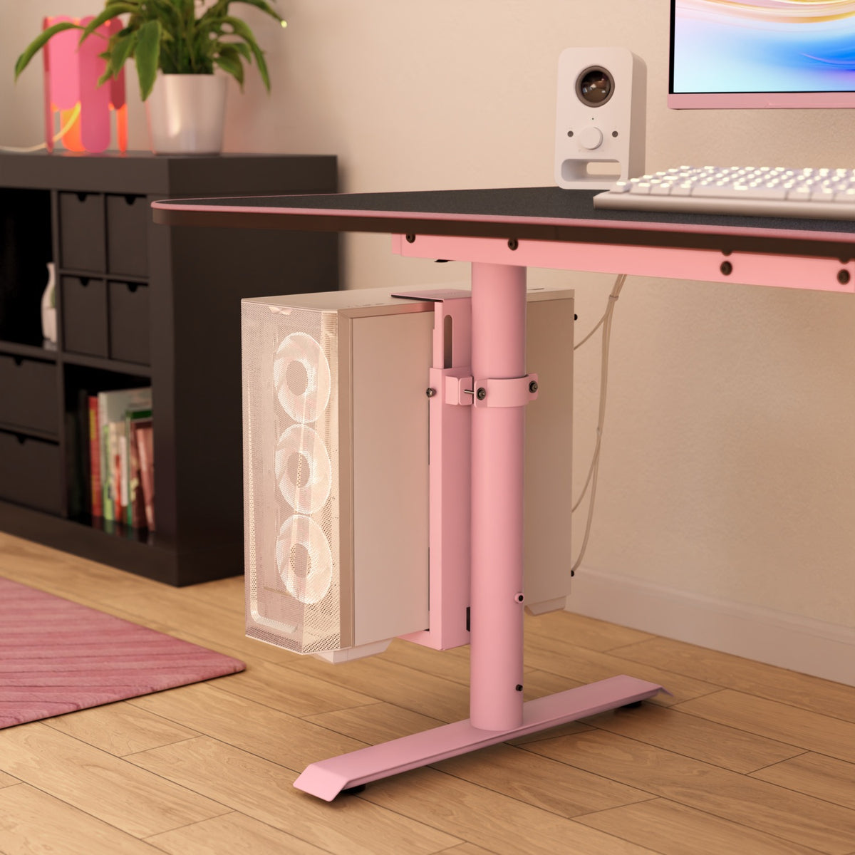 Arozzi Arena PC Mount holds a white PC with RGB fans under a pink desk in a modern room.