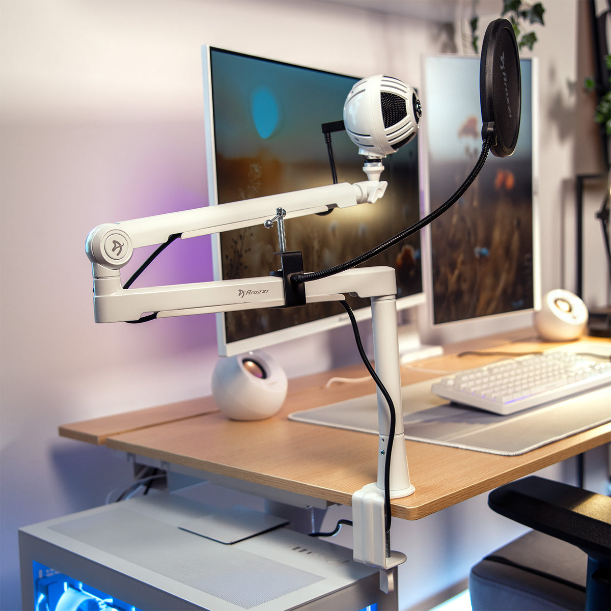 Arozzi Europe Pop Filter with white mic on adjustable arm by monitor and keyboard in home office.