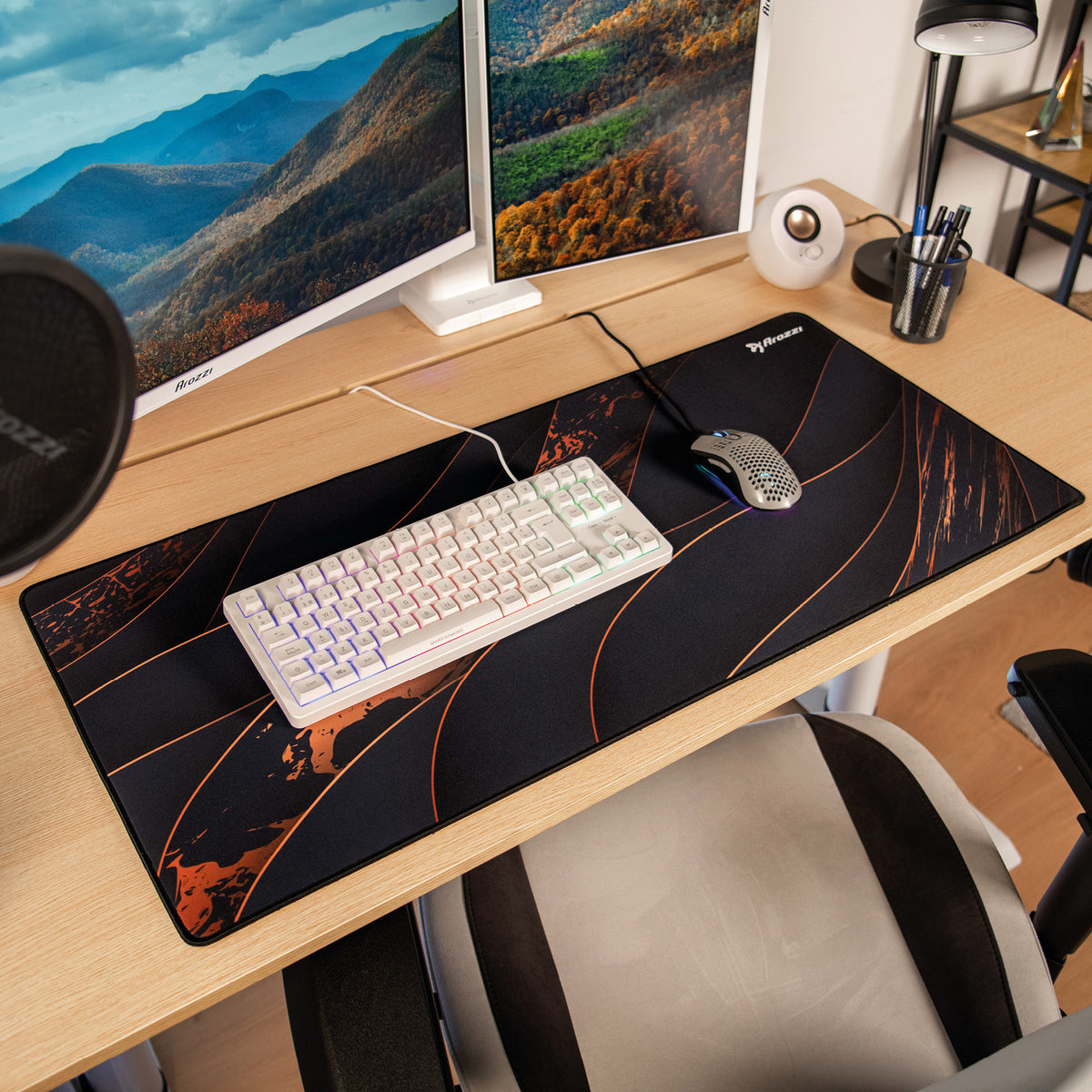 A computer desk with Arozzi Europe Zona Mousepad - Extra Large, keyboard, monitors, and chair.