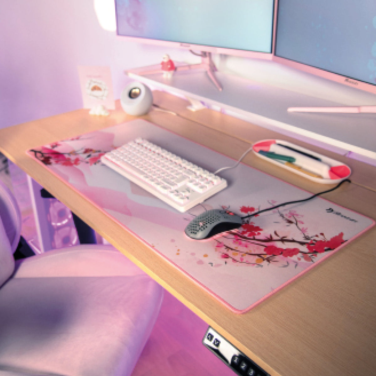 A pastel pink desk with a white keyboard and Arozzi Zona Mousepad - Extra Large by Arozzi Europe.